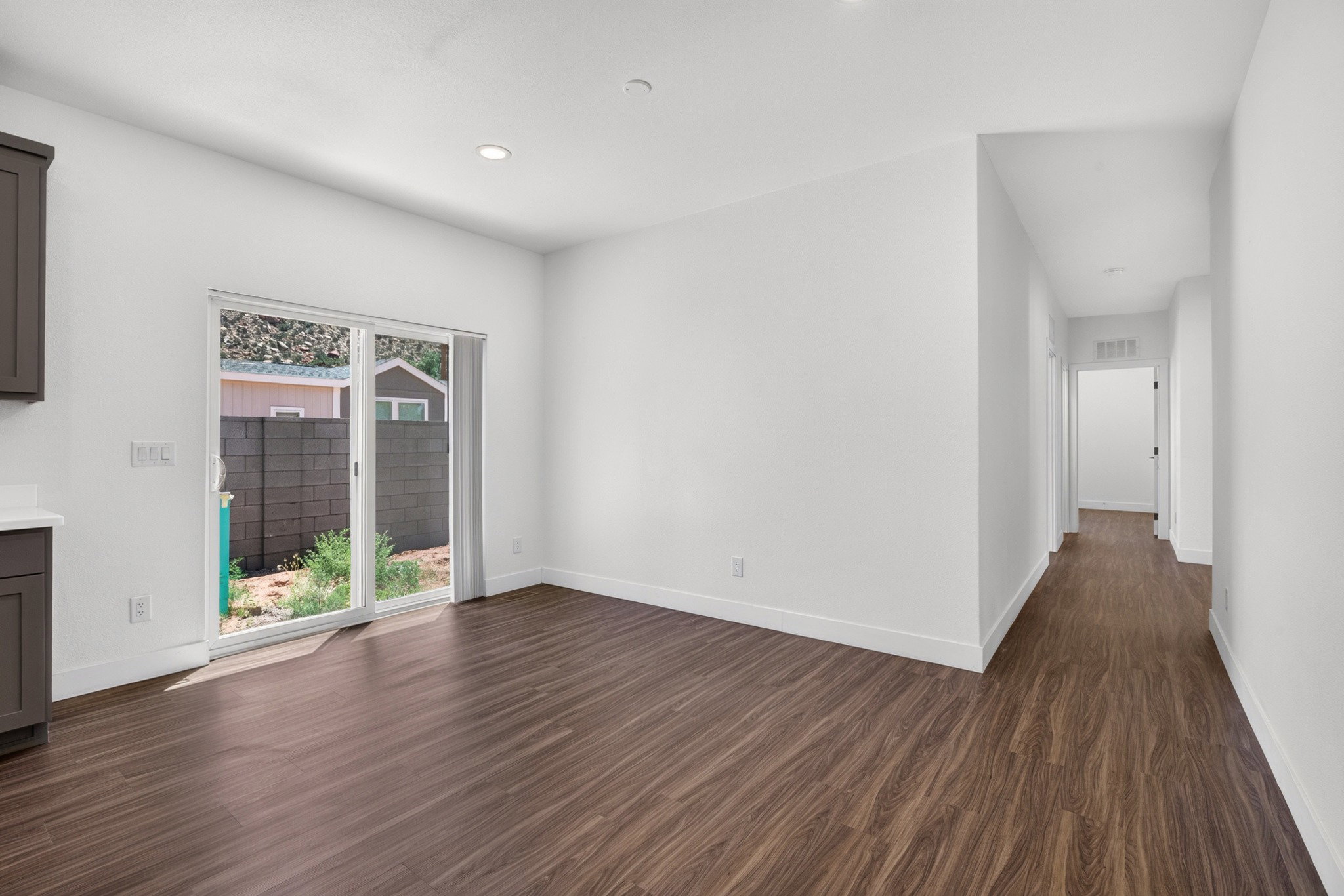 Bright interior space featuring wood-finish flooring, recessed lighting, and a sliding glass door