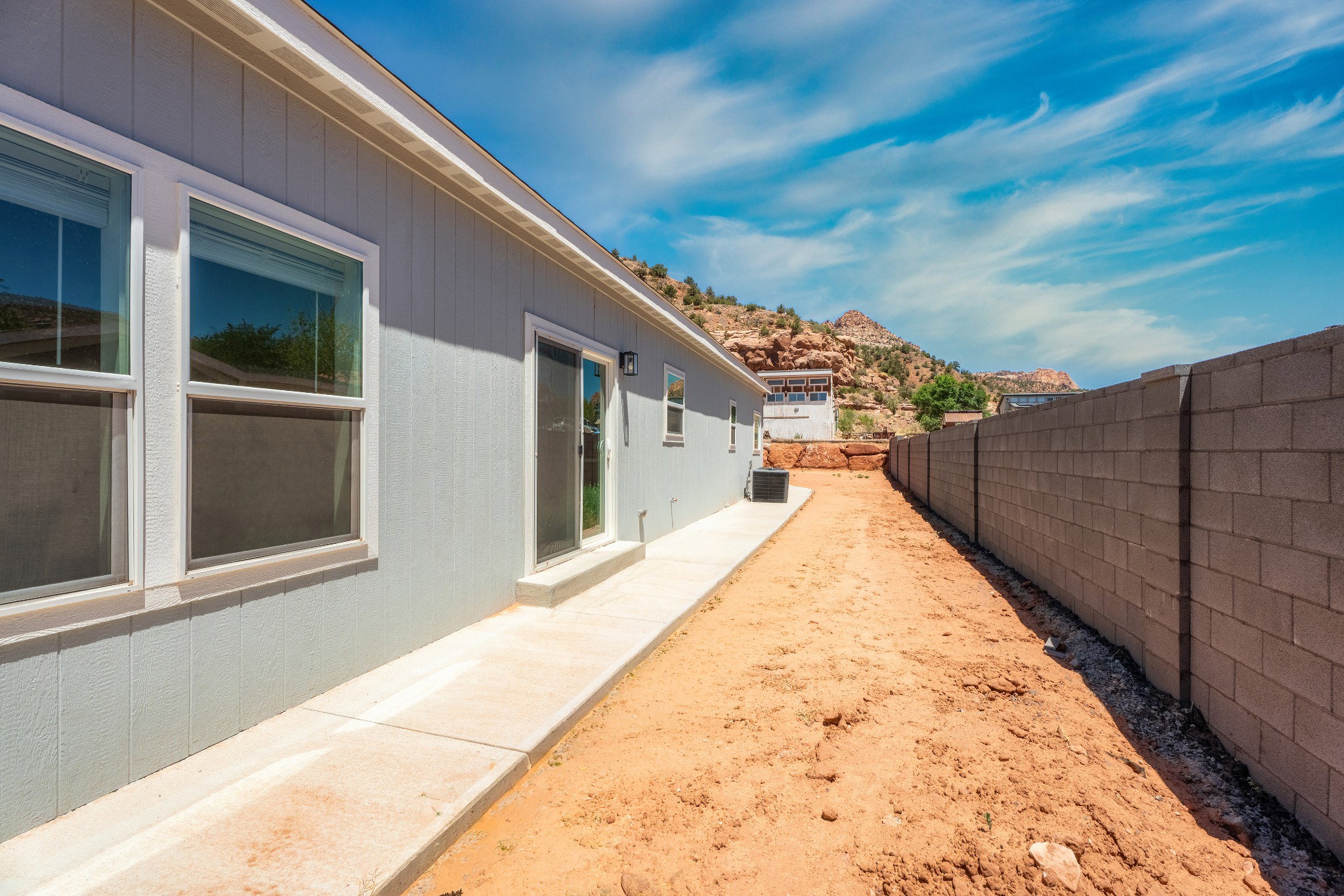 Exterior siding with multiple windows and a sliding glass door