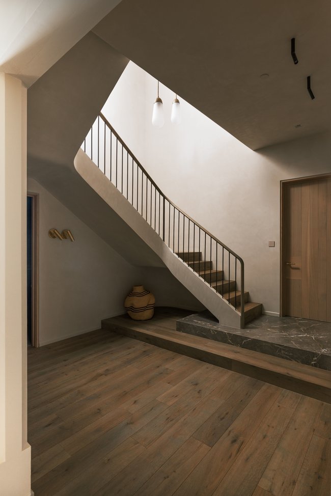Curved staircase with black metal railing