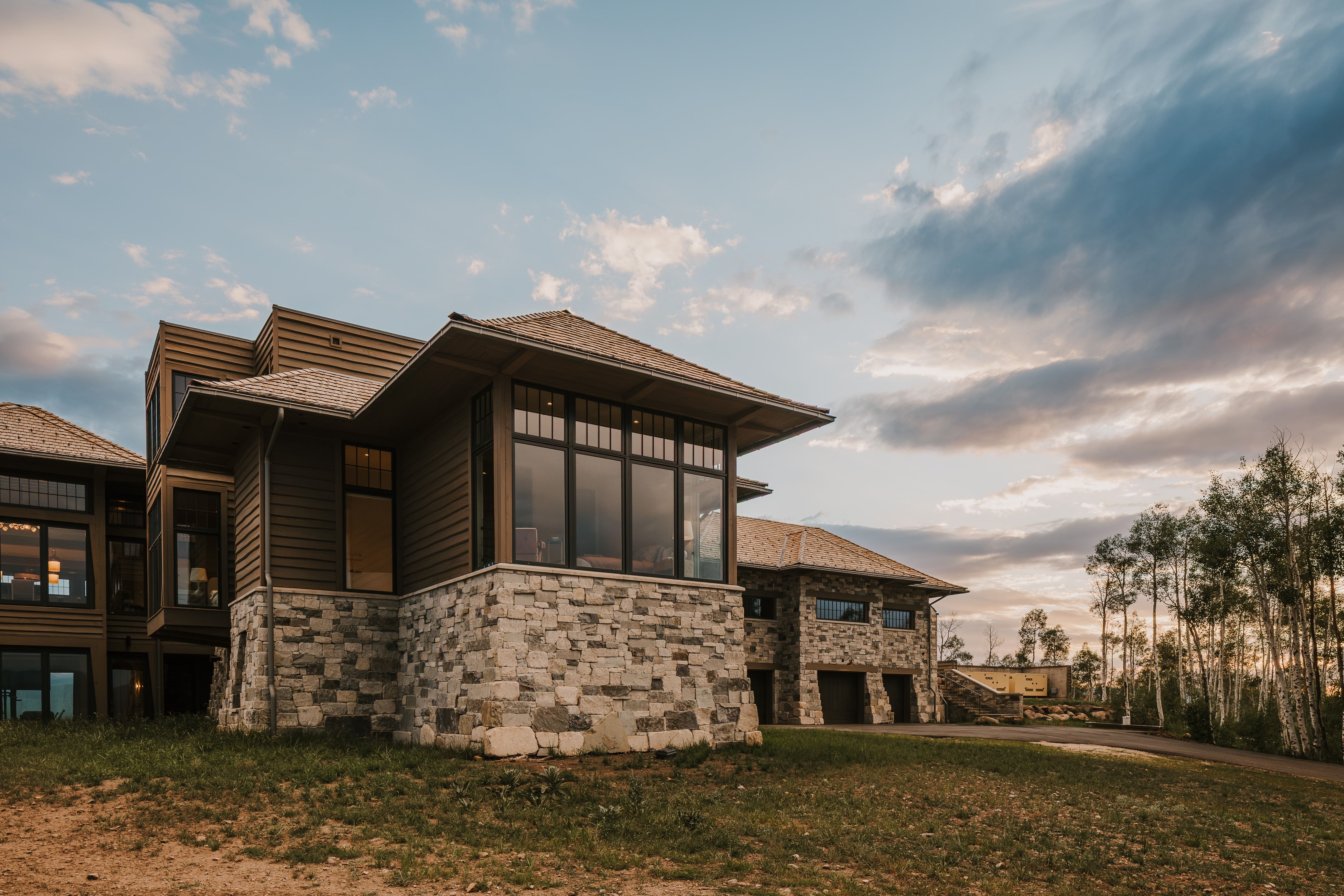 Contemporary residence featuring a multi-level design with stone and wood siding
