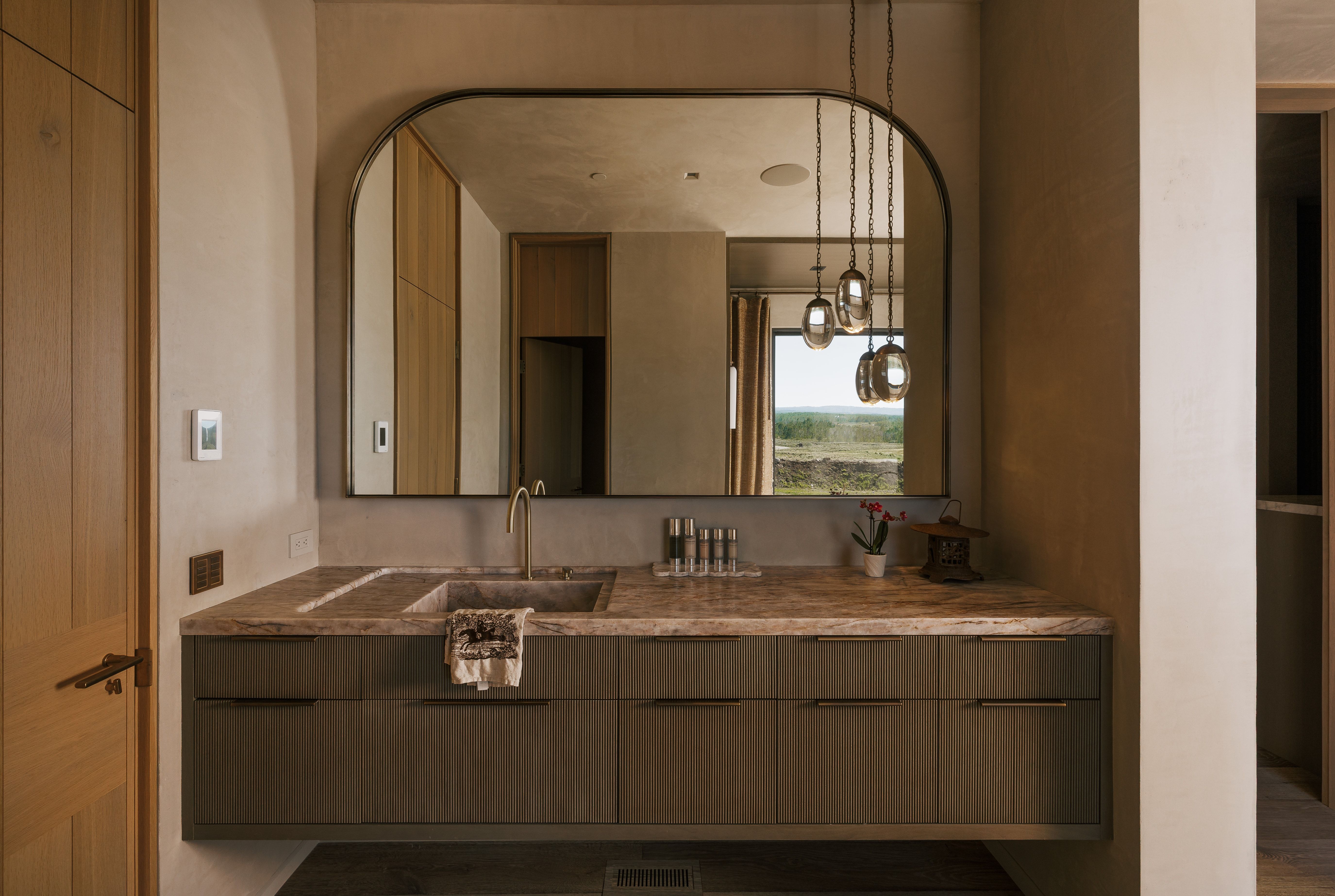 Floating vanity with an integrated basin and a substantial stone countertop