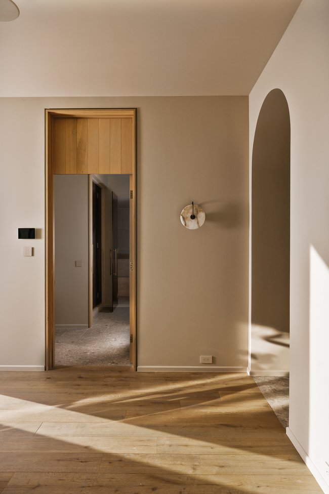 Warm wood-finish flooring complements neutral wall tones