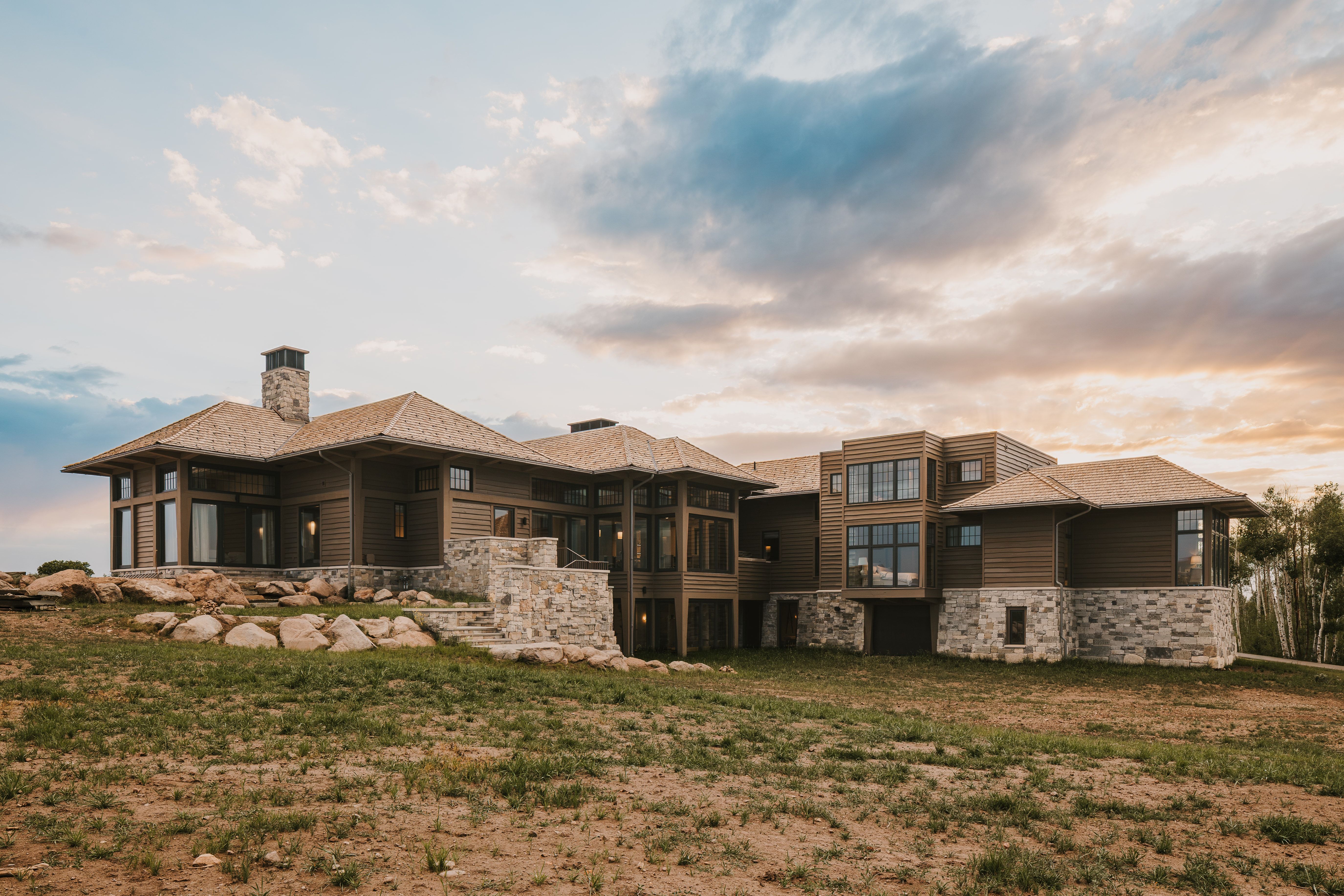 Contemporary multi-level residence featuring wood siding and stone accents