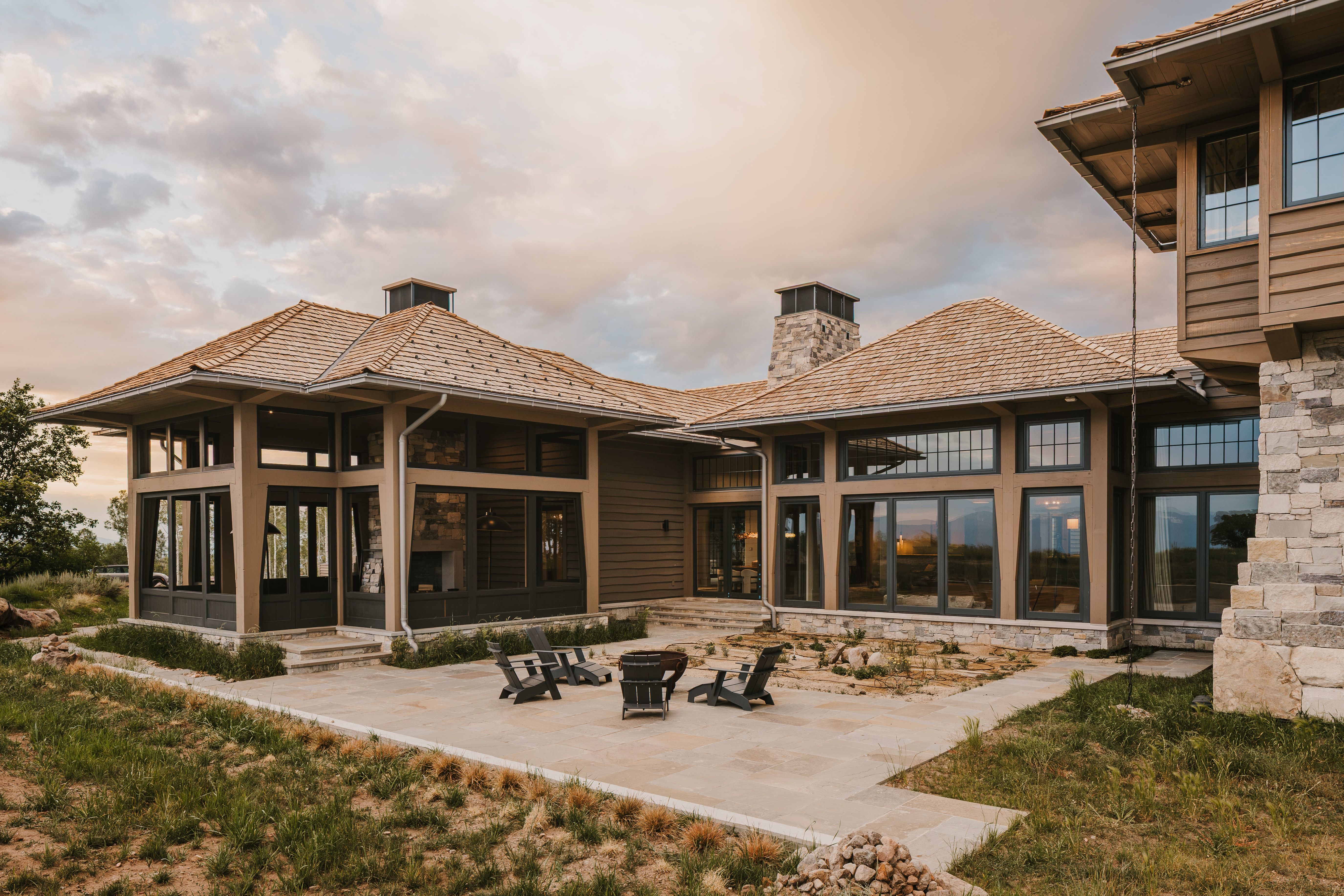 Expansive patio featuring flagstone paving and a built-in fire pit