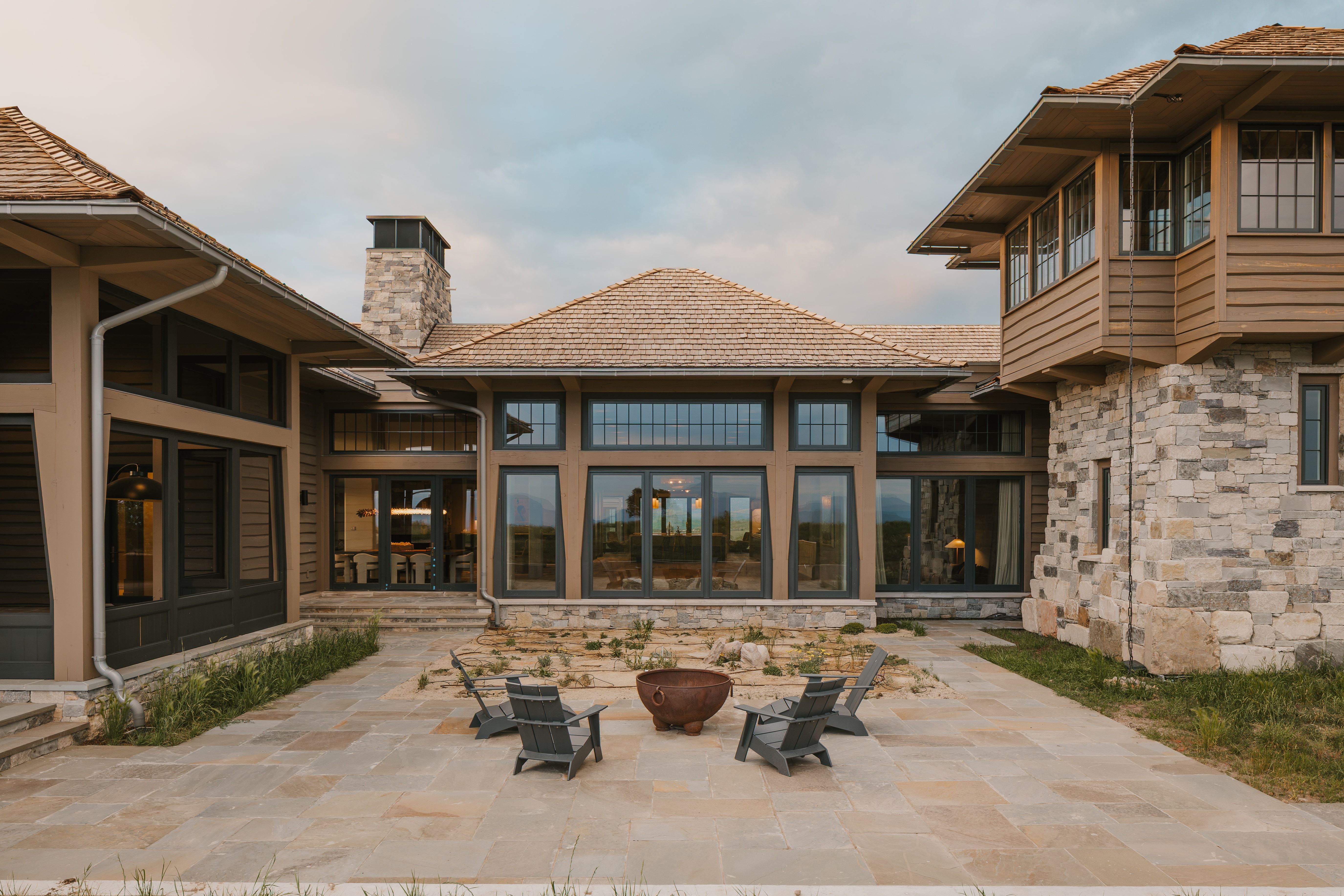 Expansive stone patio featuring a central fire pit