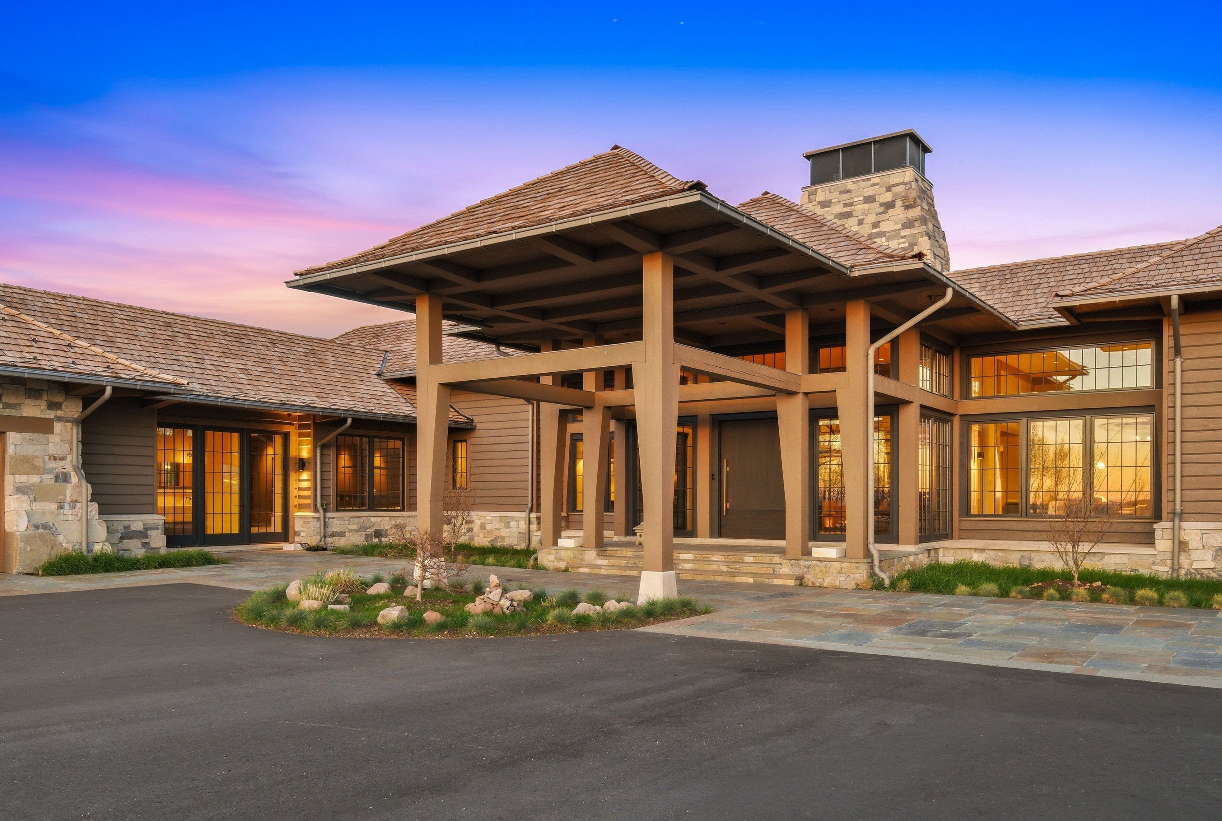 Craftsman-style entry with a porte-cochere and substantial wood beams