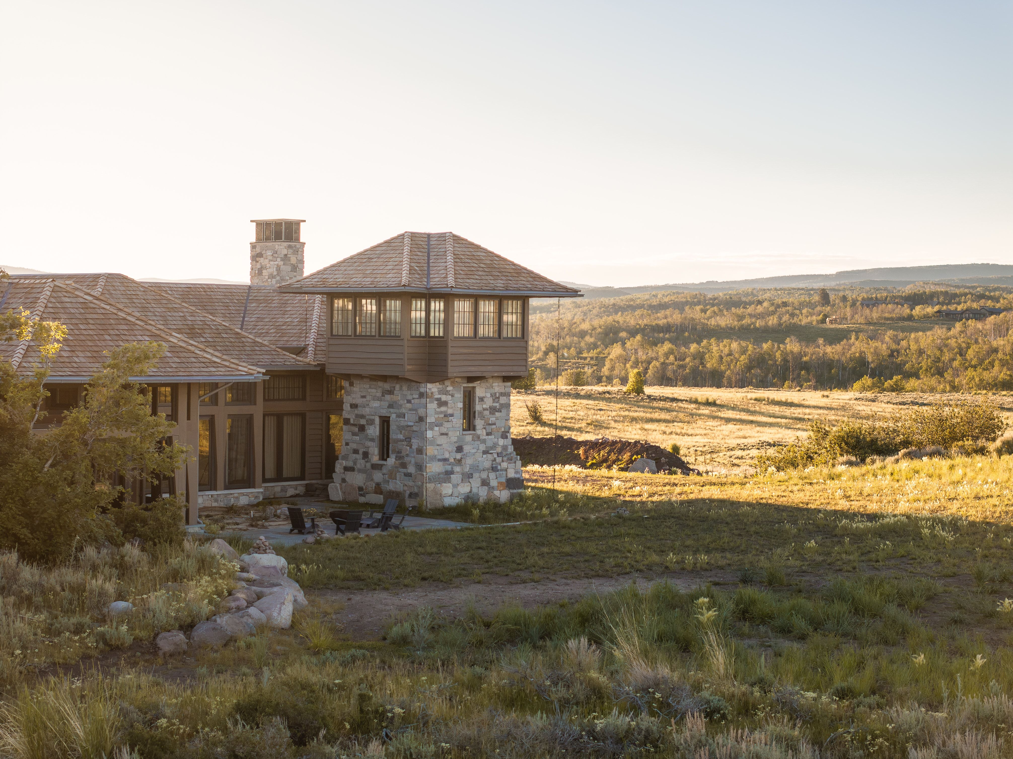 Stone and wood-sided exterior featuring a multi-level design