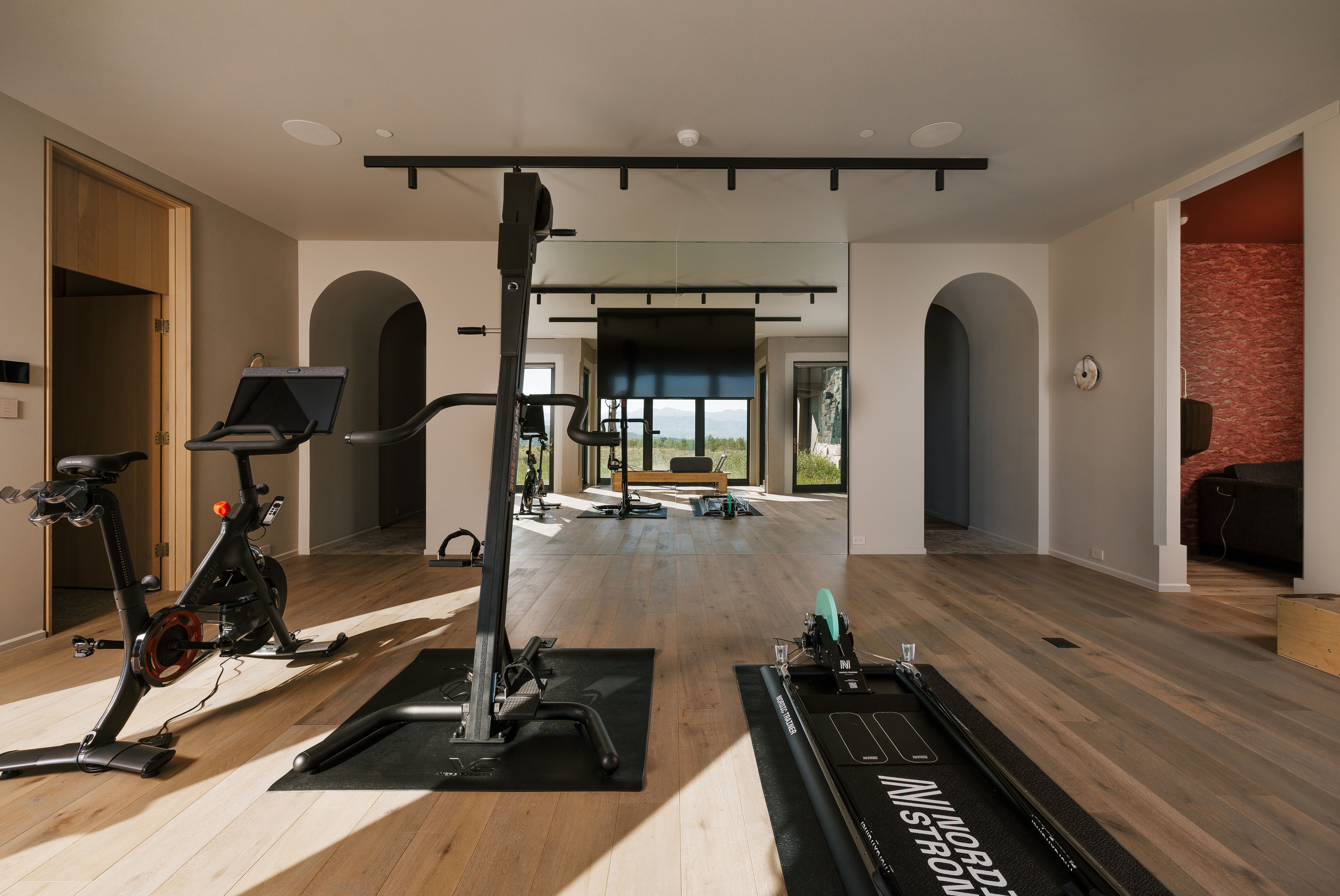 Dedicated fitness space featuring light wood-finish flooring