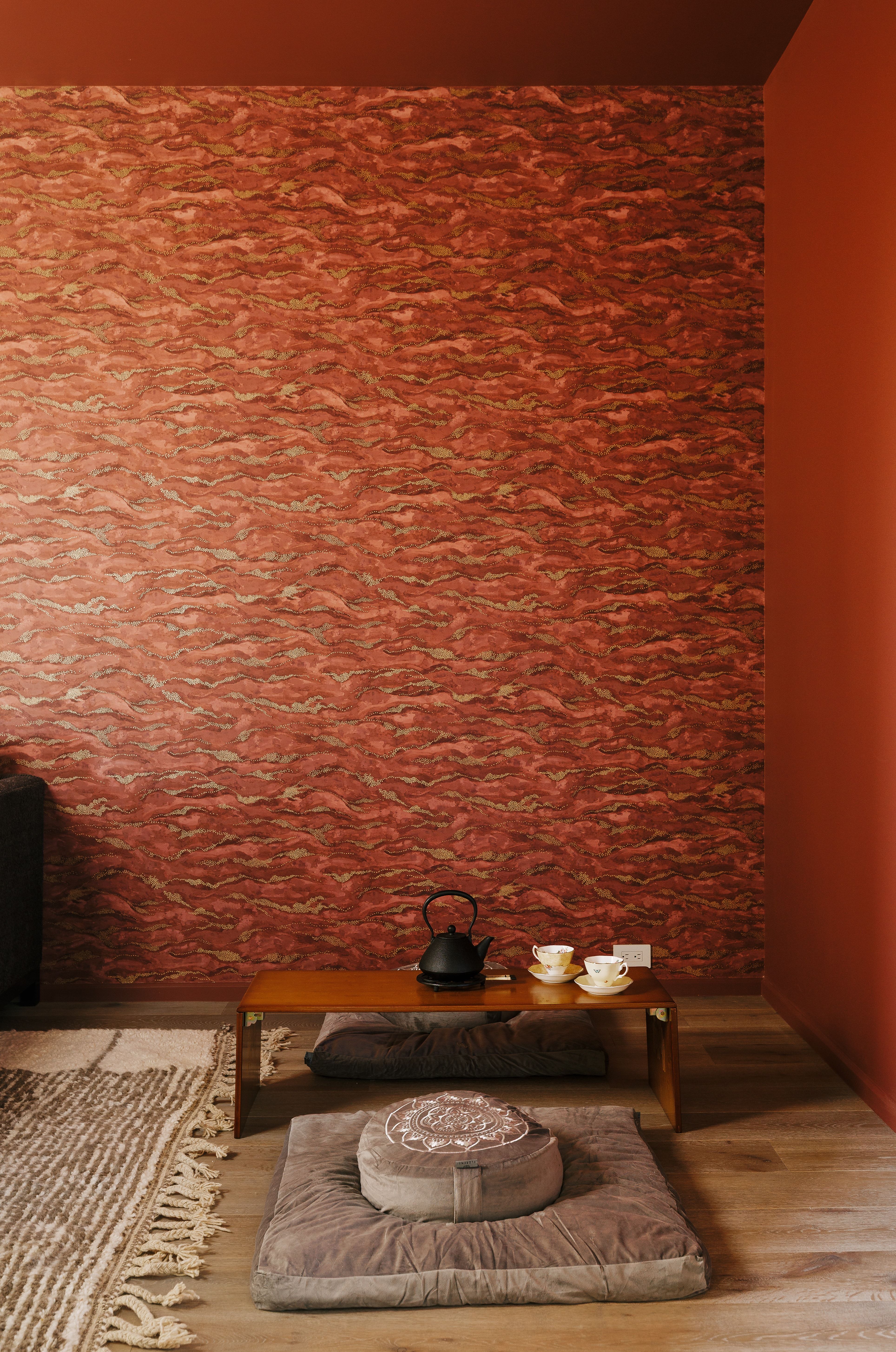 Accent wall with textured red finish, complemented by solid red painted walls and ceiling