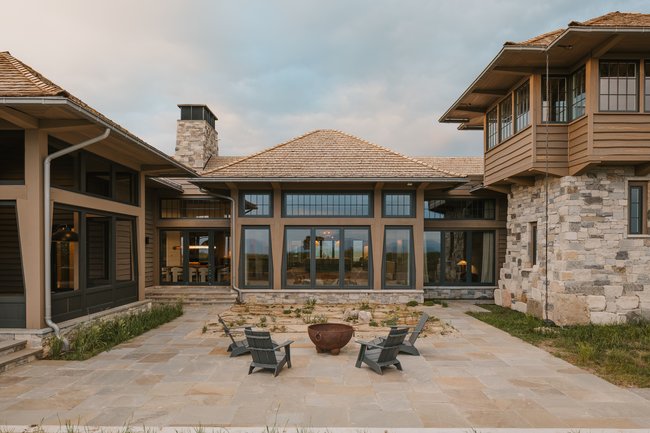 Spacious stone patio with a central fire pit feature