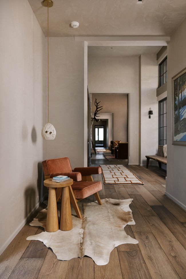 Hallway featuring wide plank wood-finish flooring, textured walls, and recessed lighting