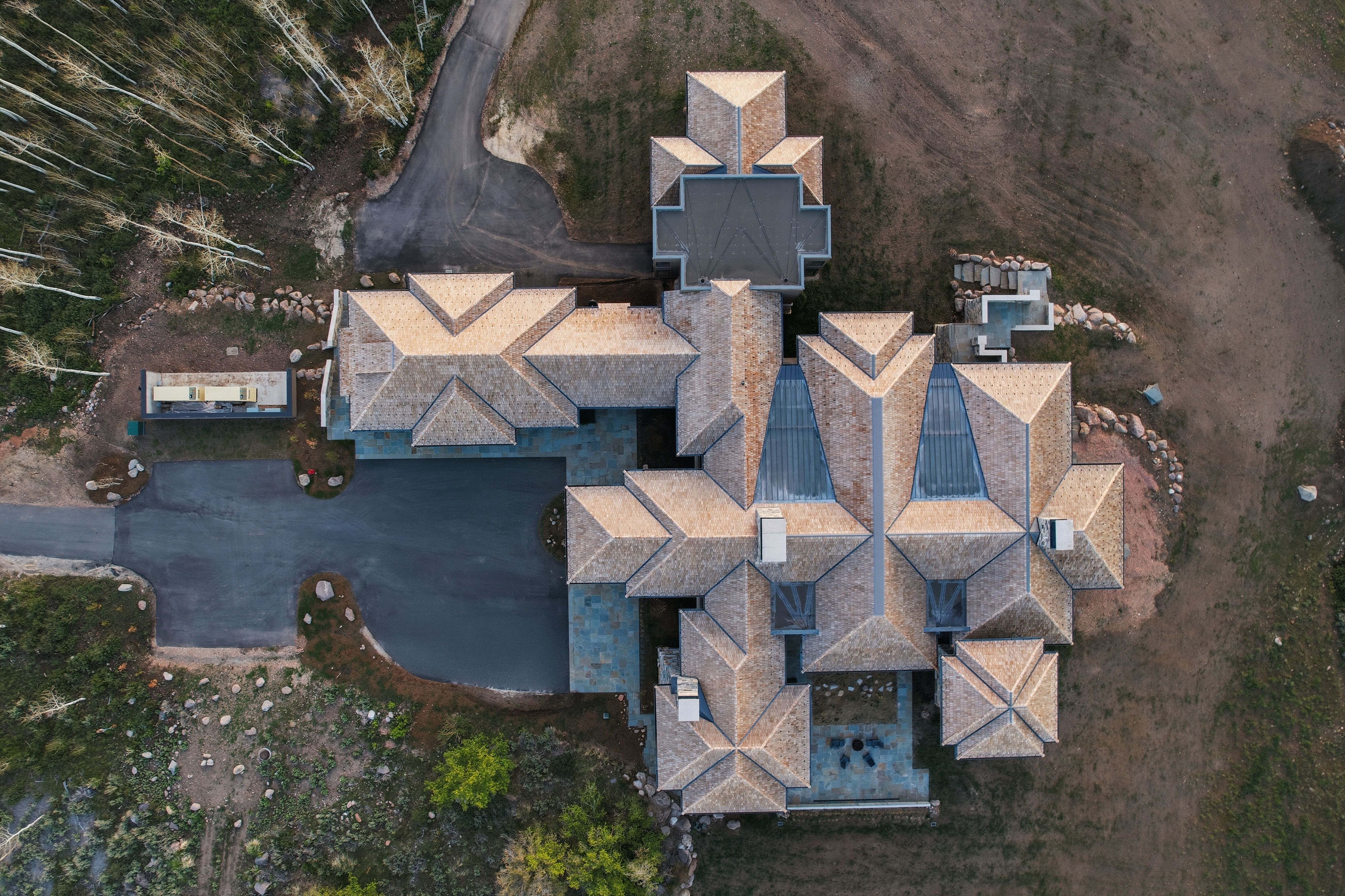 Expansive property featuring a multi-winged structure with a complex roofline and multiple skylights