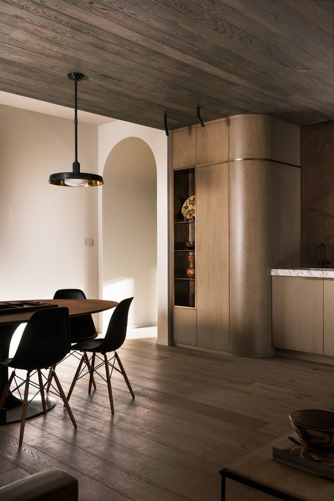 Interior dining area with wood-finish flooring and a matching wood-finish paneled ceiling