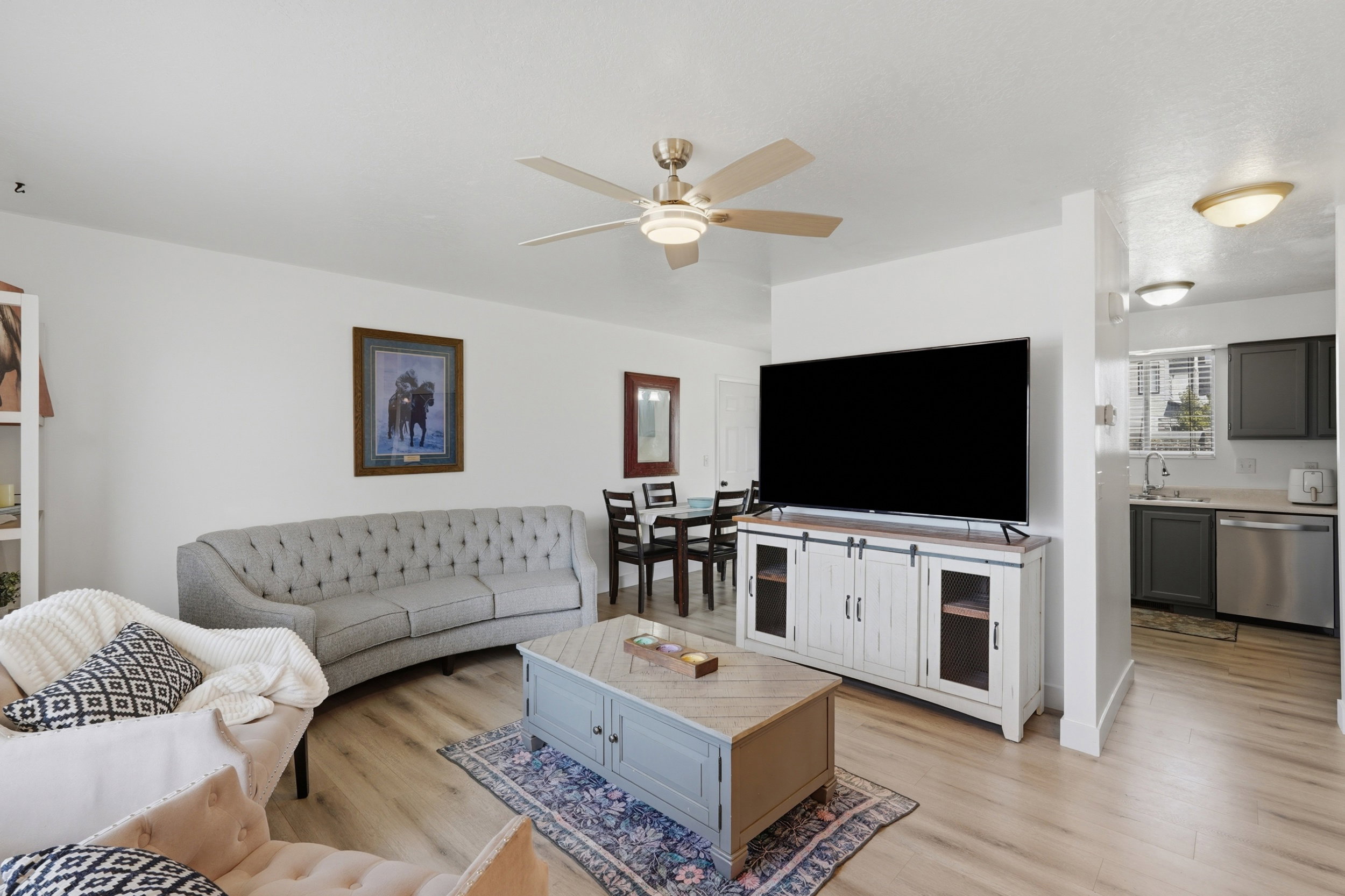 Open-concept living area featuring wood-finish flooring, a contemporary ceiling fan, and recessed lighting
