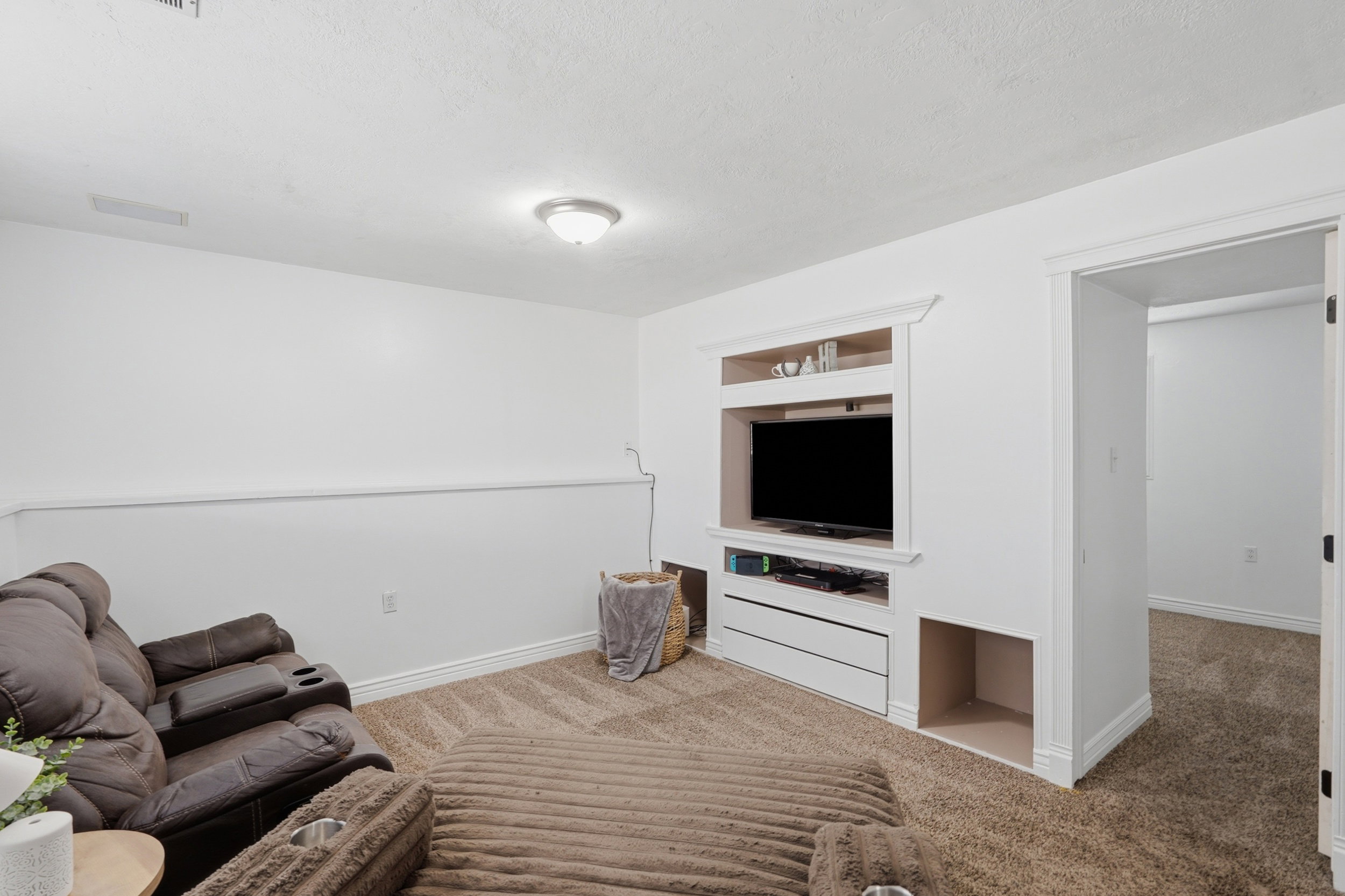 Room featuring a built-in media console with storage drawers and open shelving
