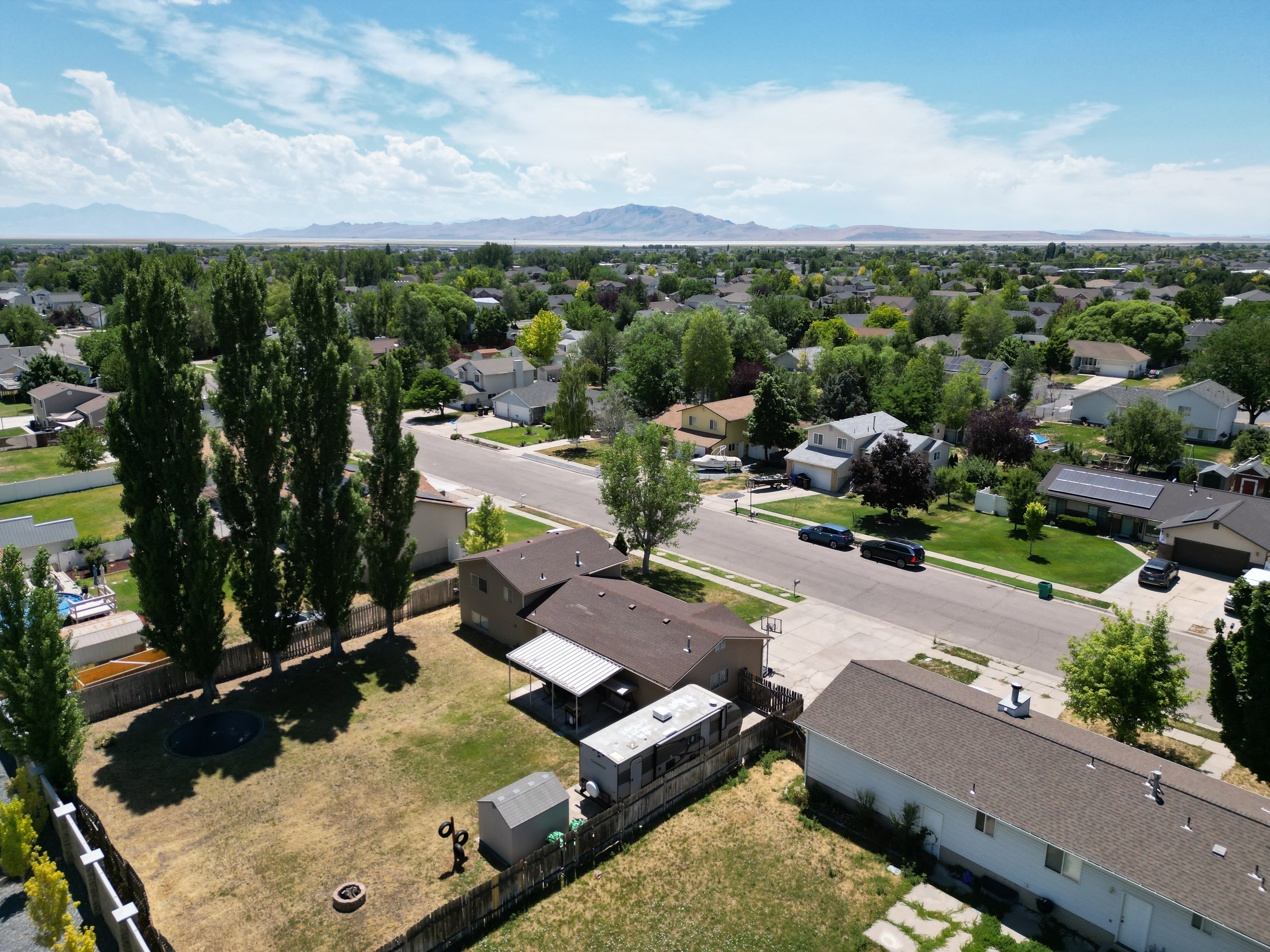 Expansive backyard featuring a fenced perimeter and mature trees