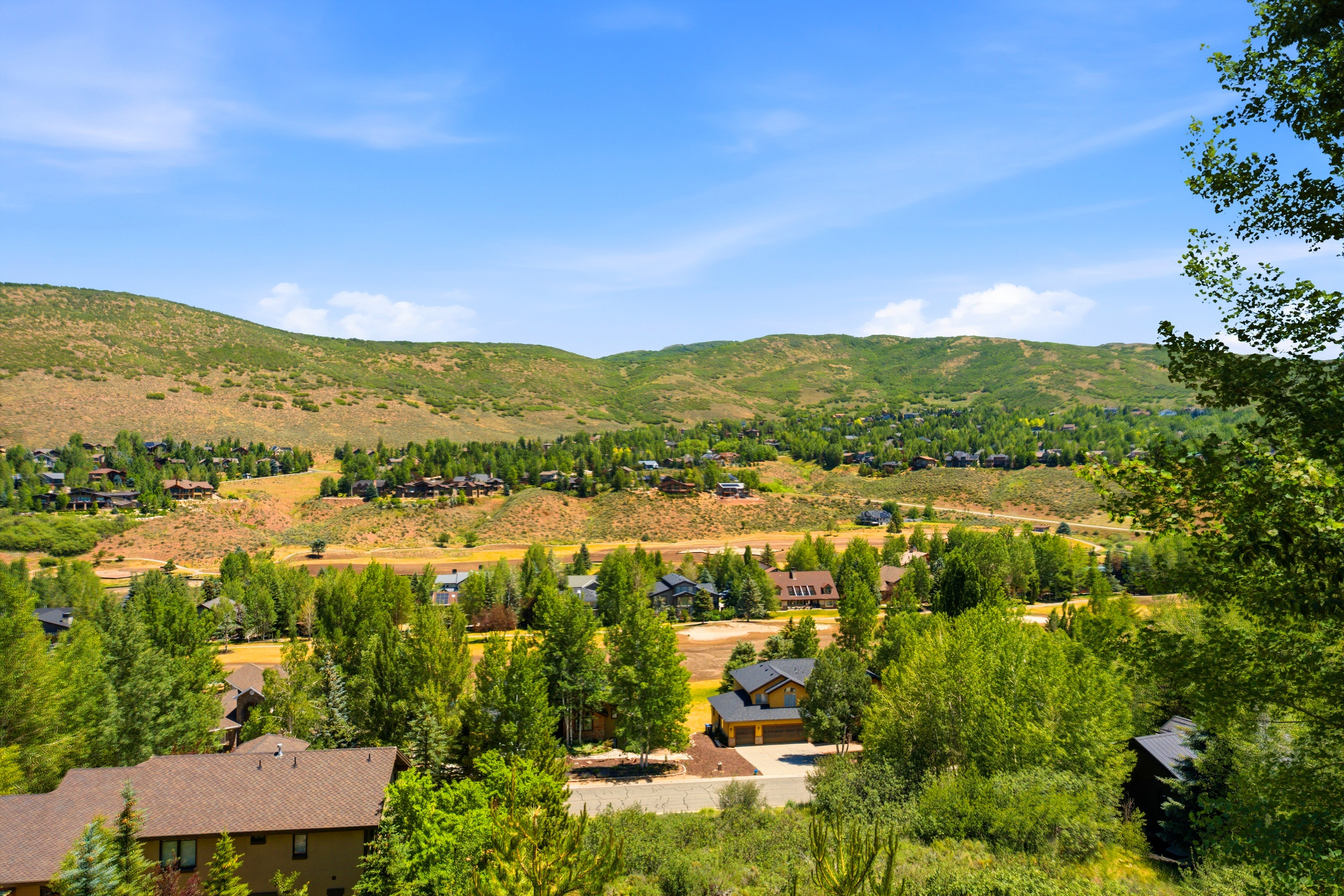 Mountainous terrain featuring expansive natural landscaping and numerous residential properties