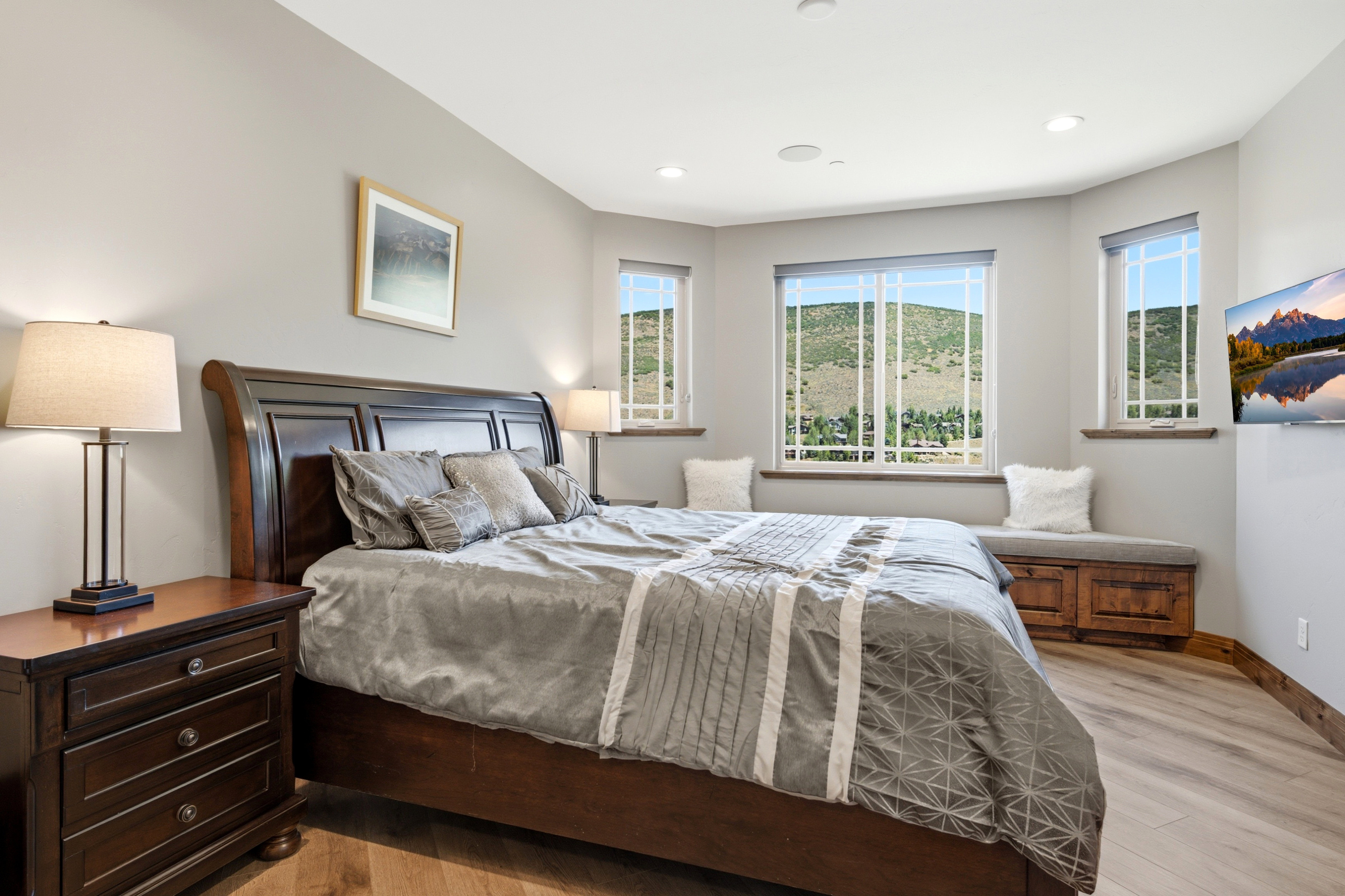 Light wood-finish flooring complements the neutral wall color