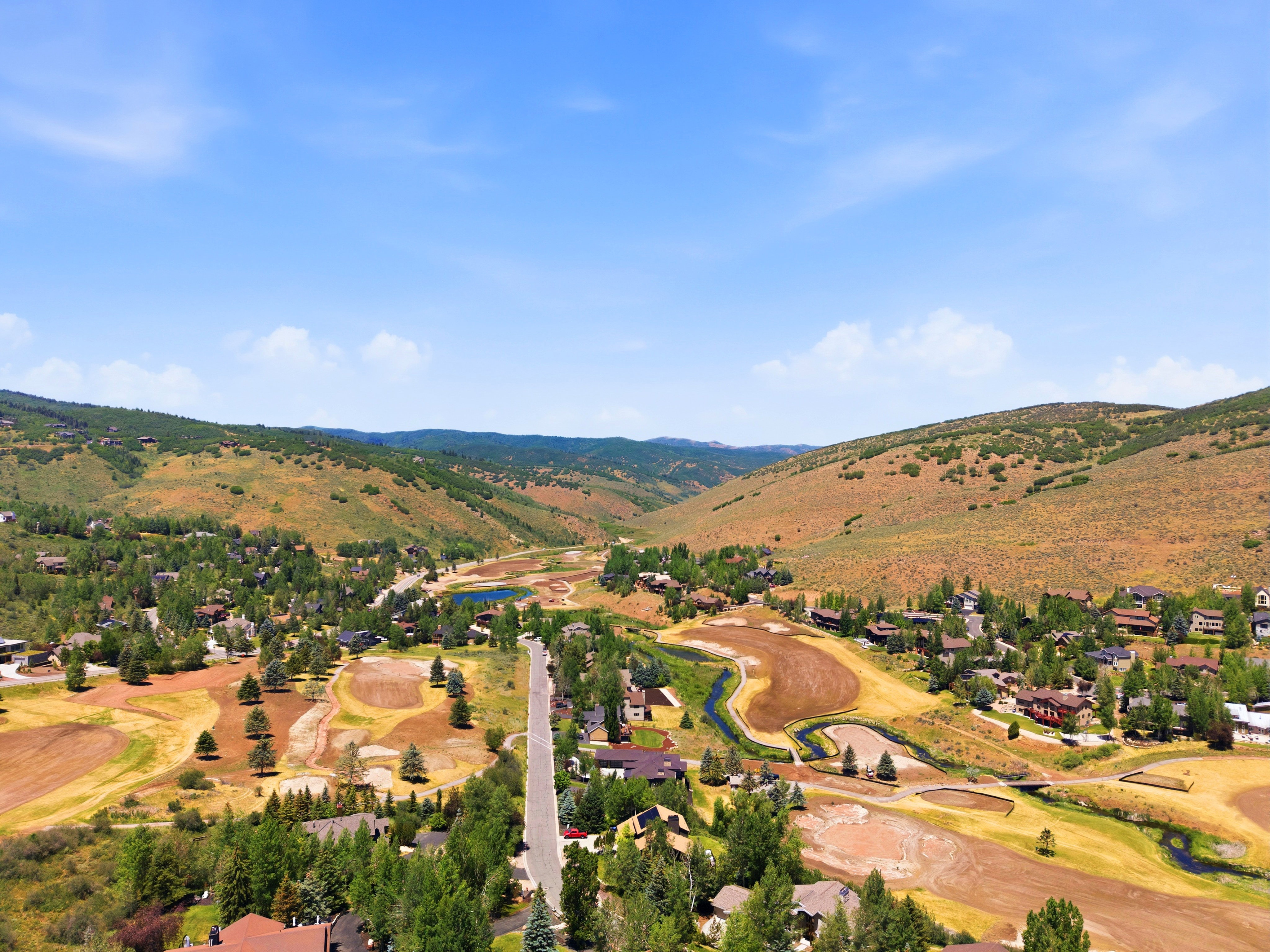 Valley landscape featuring residential properties and expansive natural surroundings