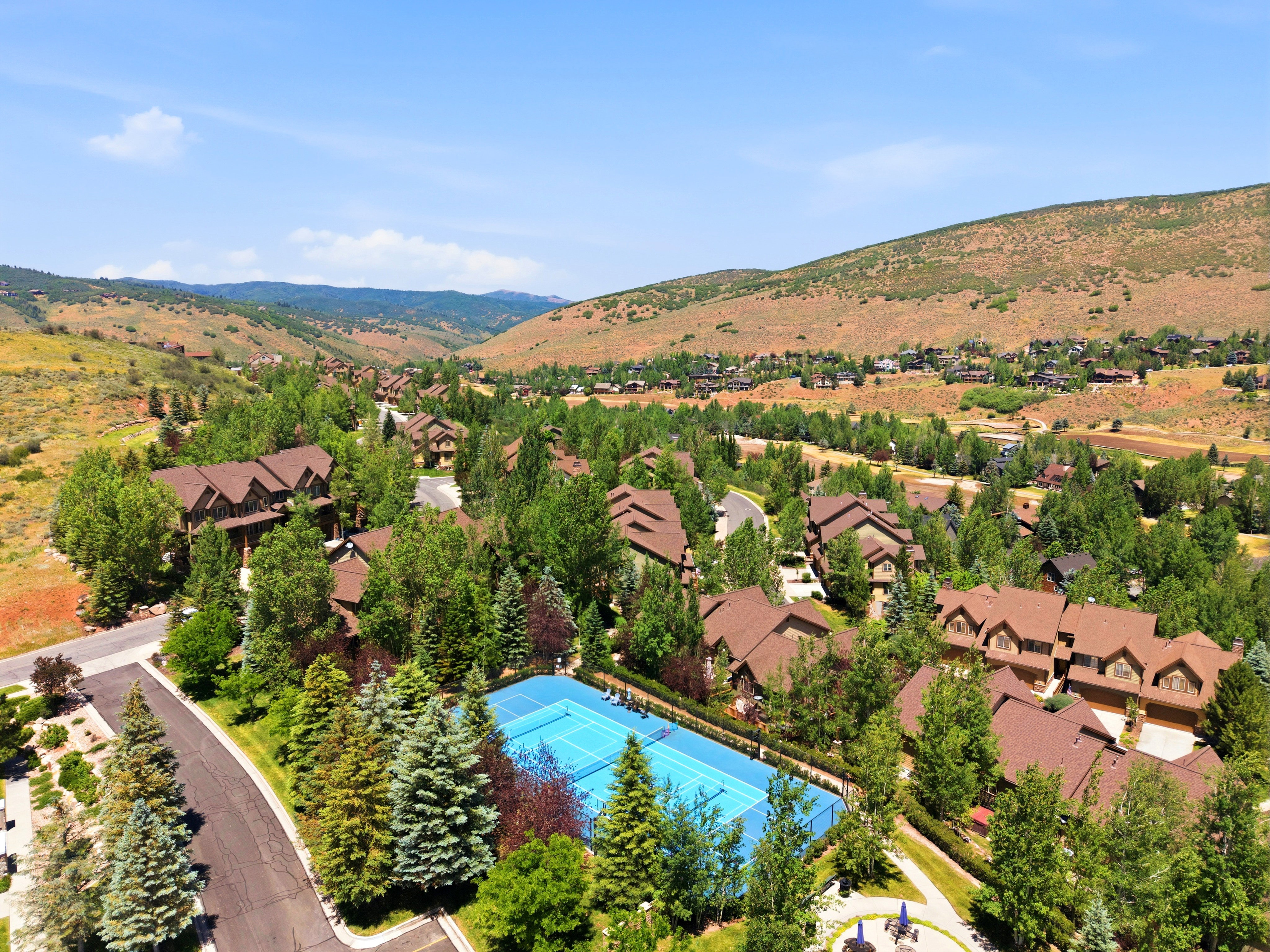 Aerial perspective showcasing a residential community nestled within a mountainous landscape