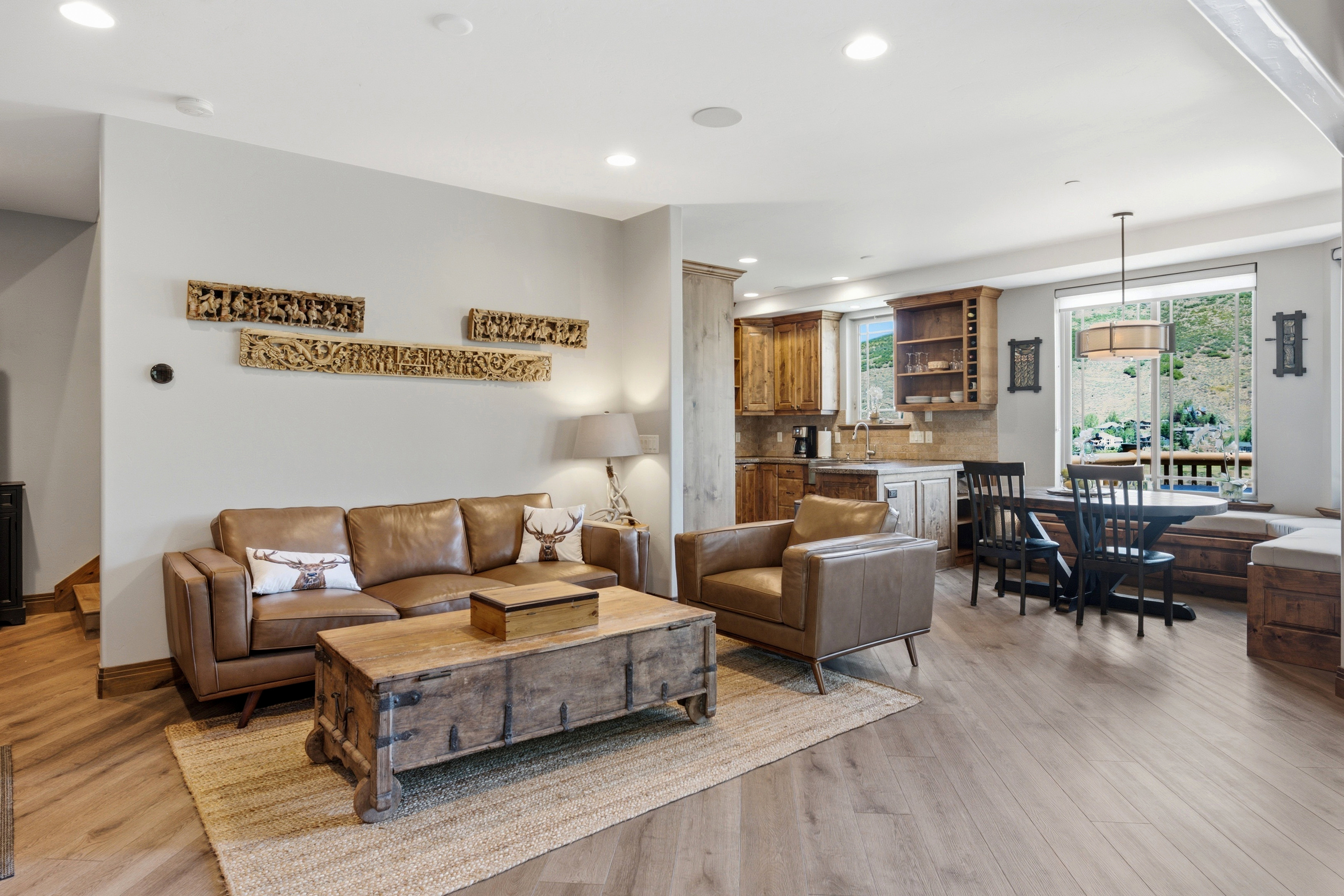 Open-concept living space featuring wood-finish flooring, recessed lighting, and a neutral color palette