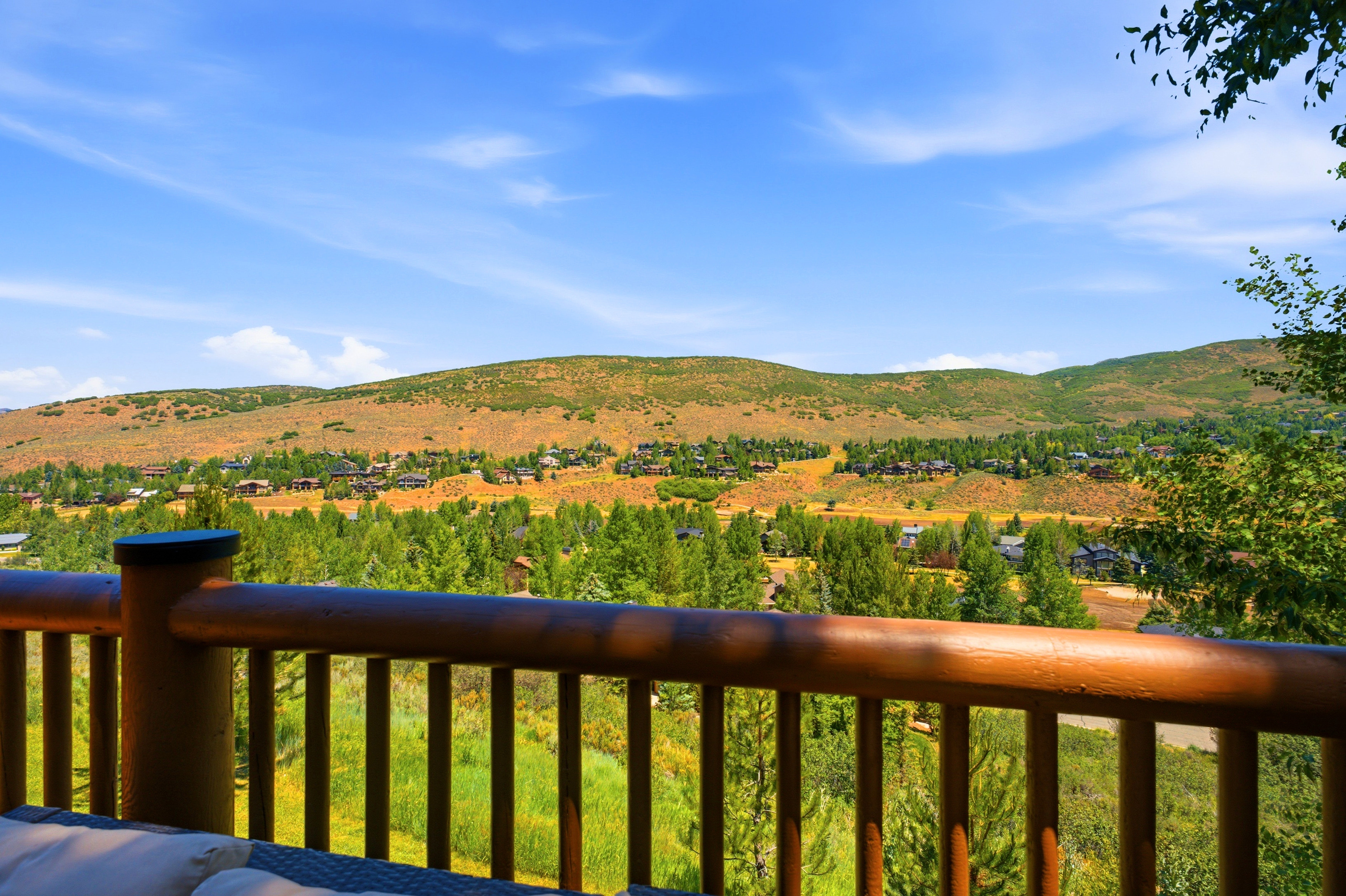 Log railing framing expansive mountain and valley scenery