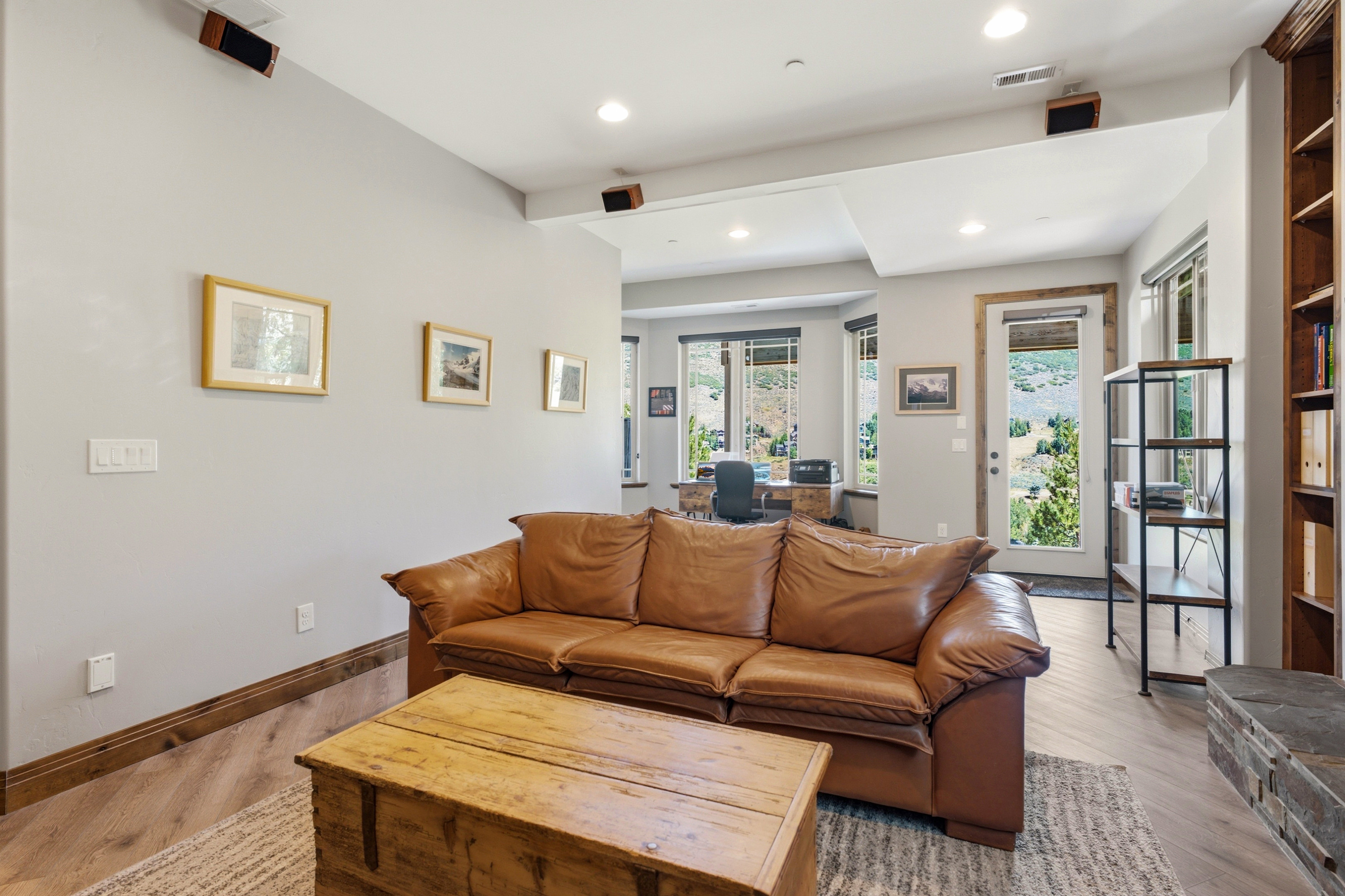 Living space with recessed lighting and crown molding
