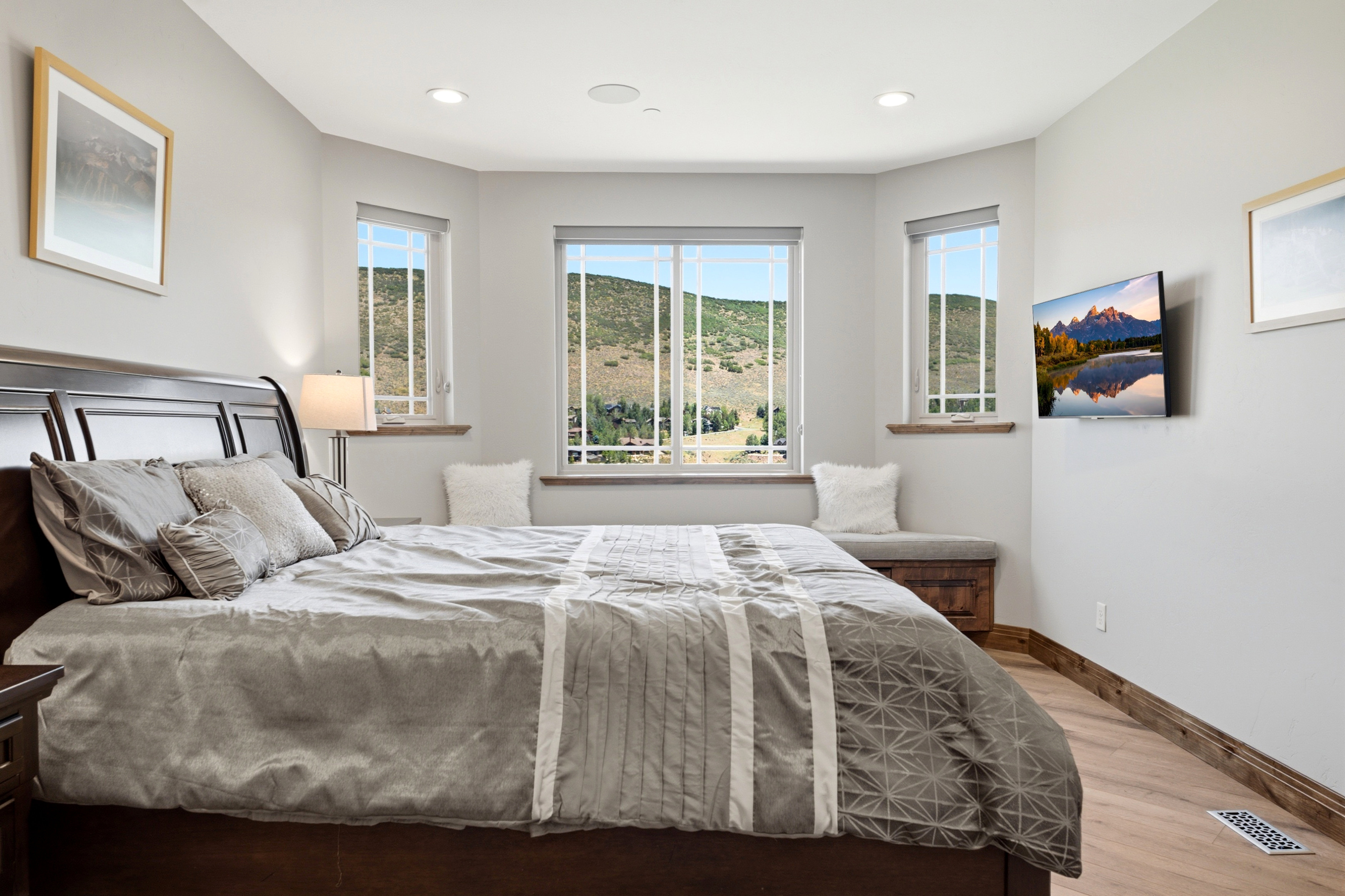 Bay window featuring three large windows showcasing mountain scenery