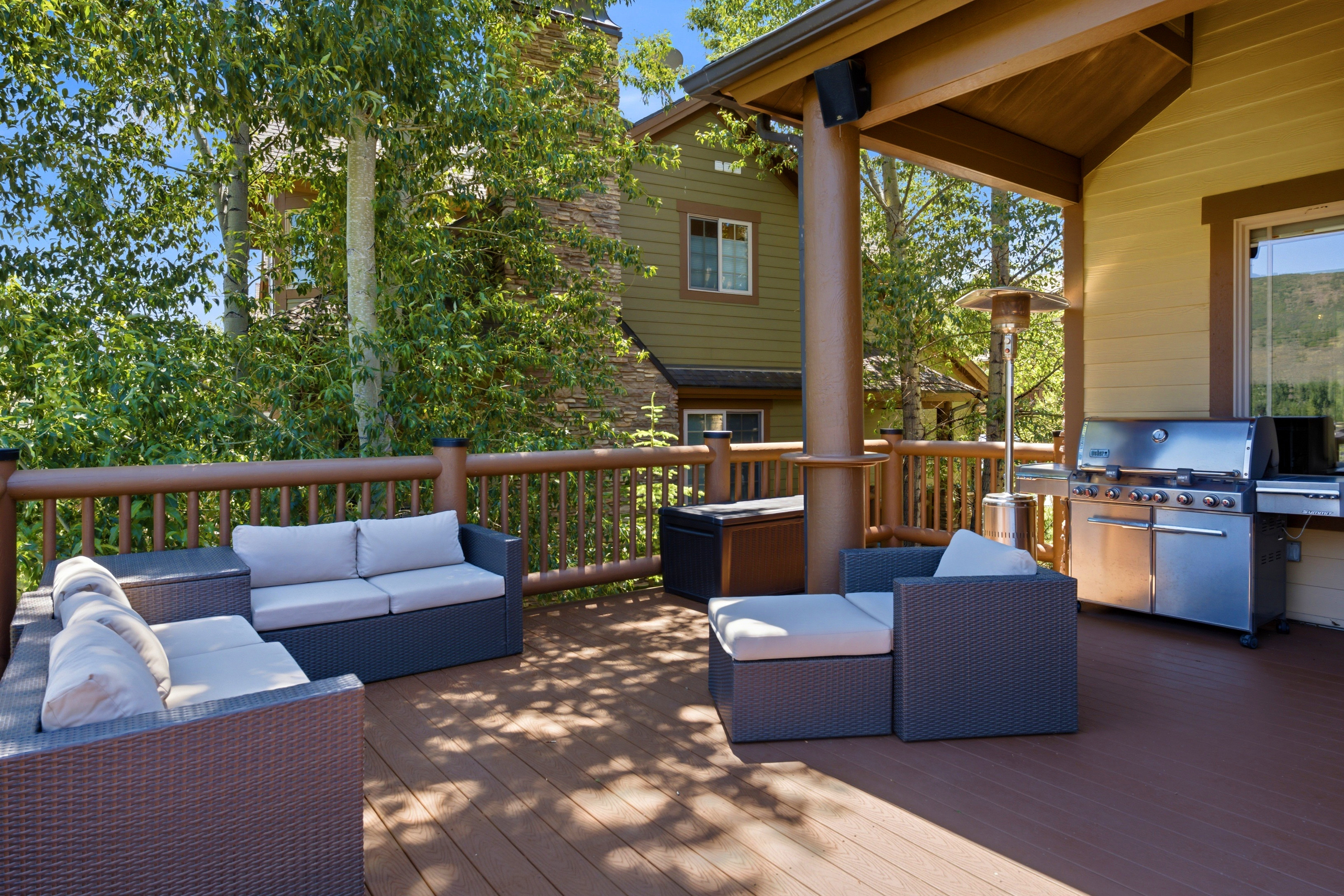 Expansive outdoor deck featuring wood-finish flooring and a wood railing system
