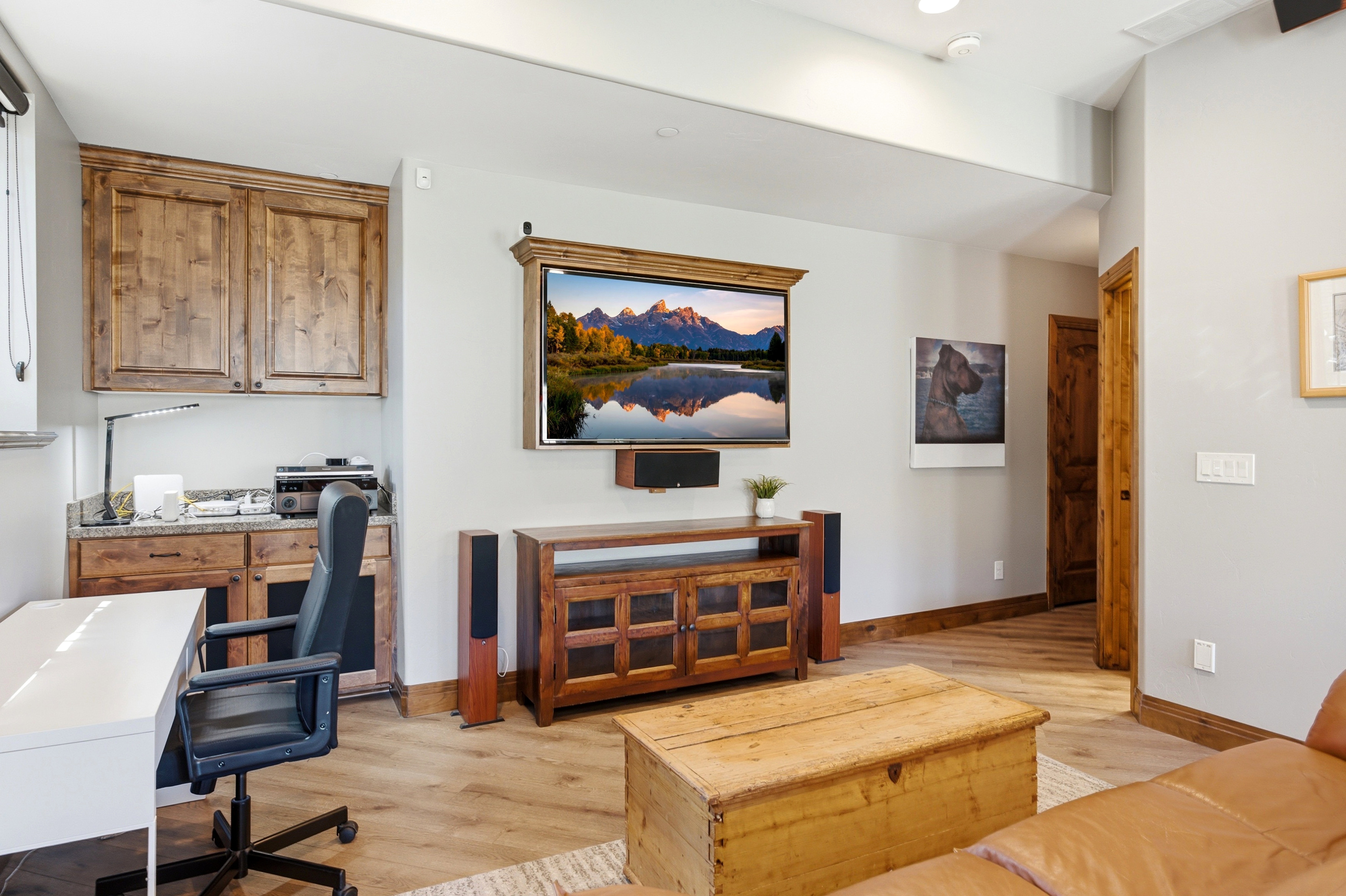 Dedicated workspace featuring built-in wood cabinetry and a stone-finish countertop