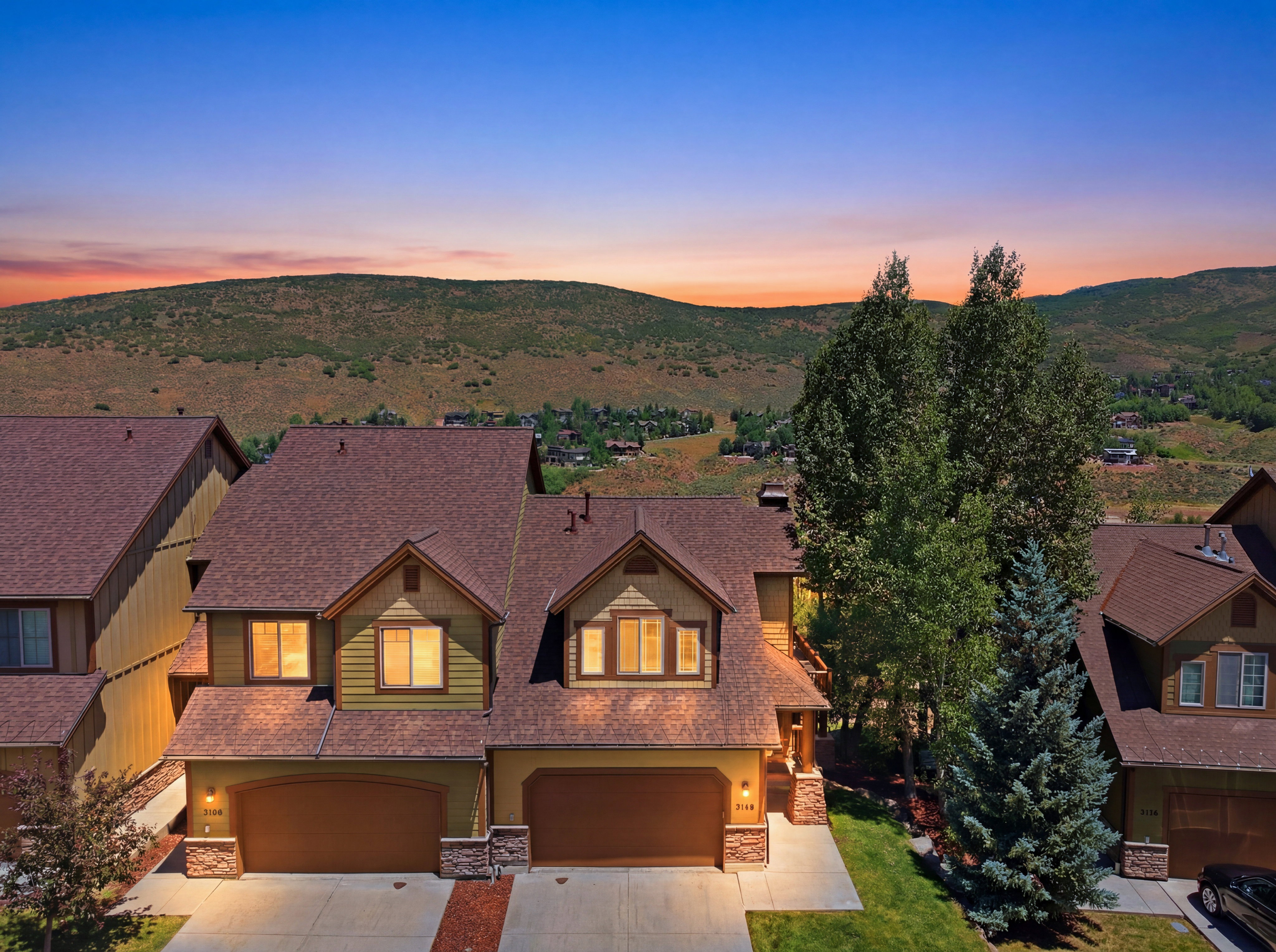 Townhome property with a multi-gabled roofline and two-car garages