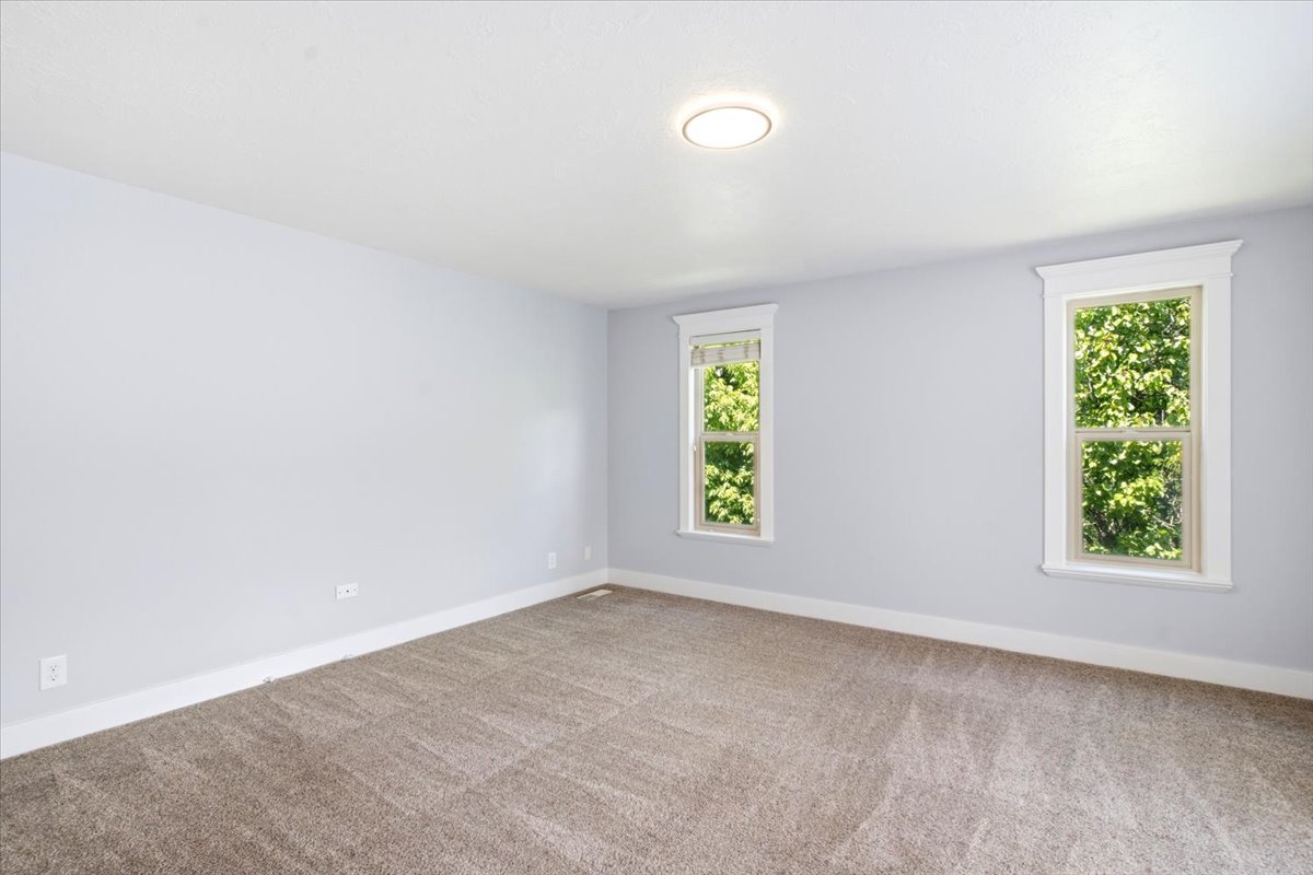 Neutral gray walls complement the new carpet flooring