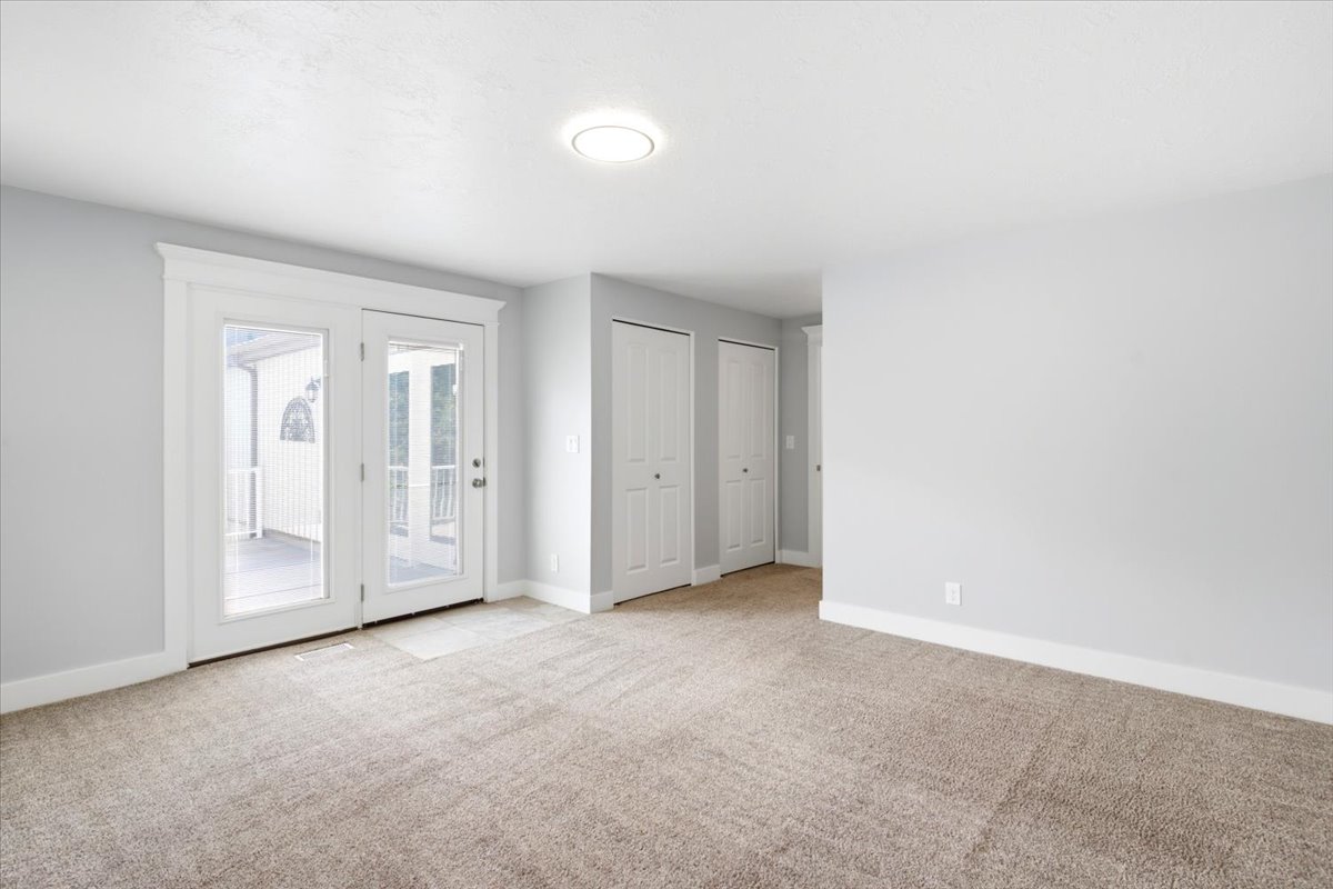 Room featuring light gray painted walls and neutral-toned carpeting