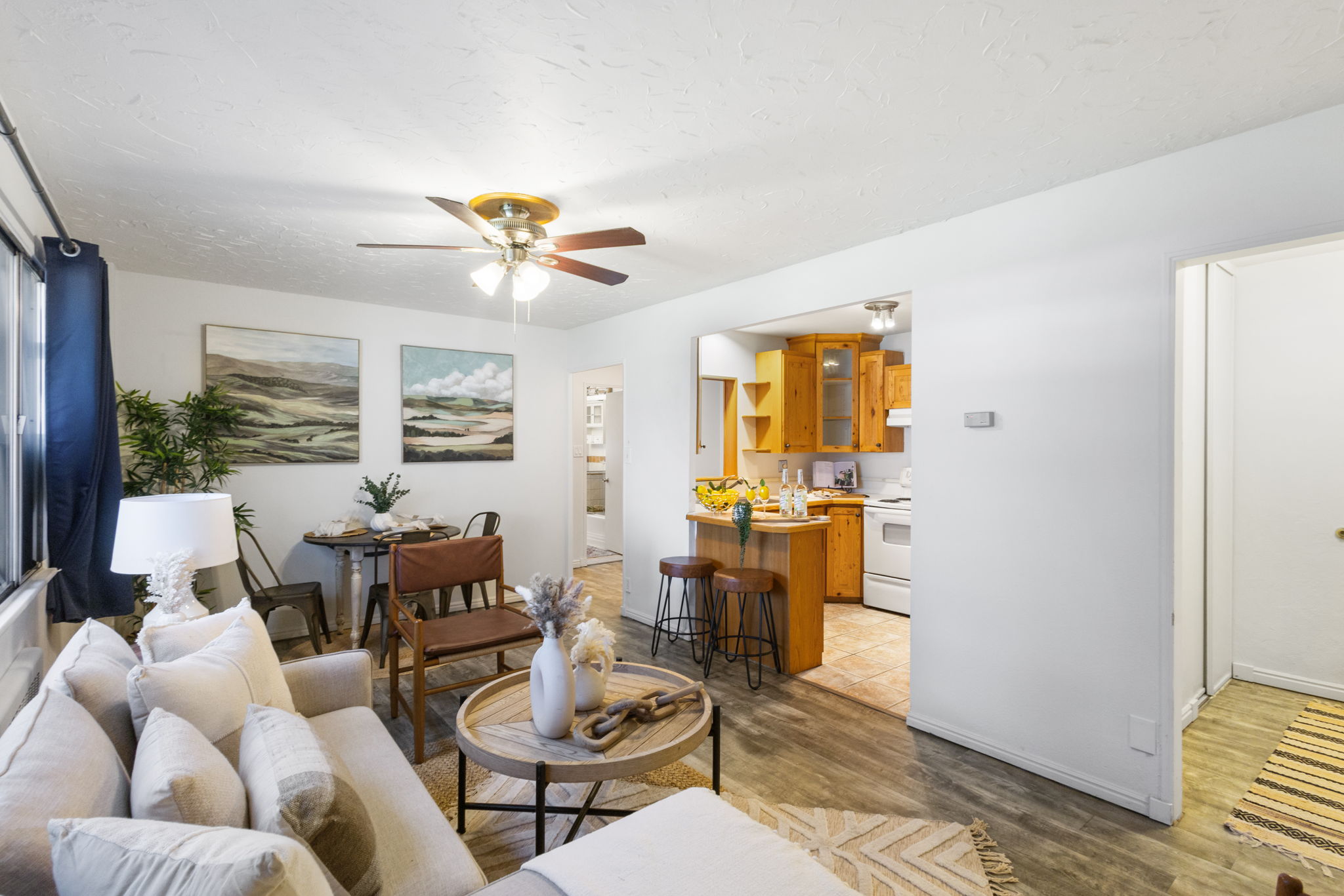 Living space featuring wood-finish flooring and a ceiling fan
