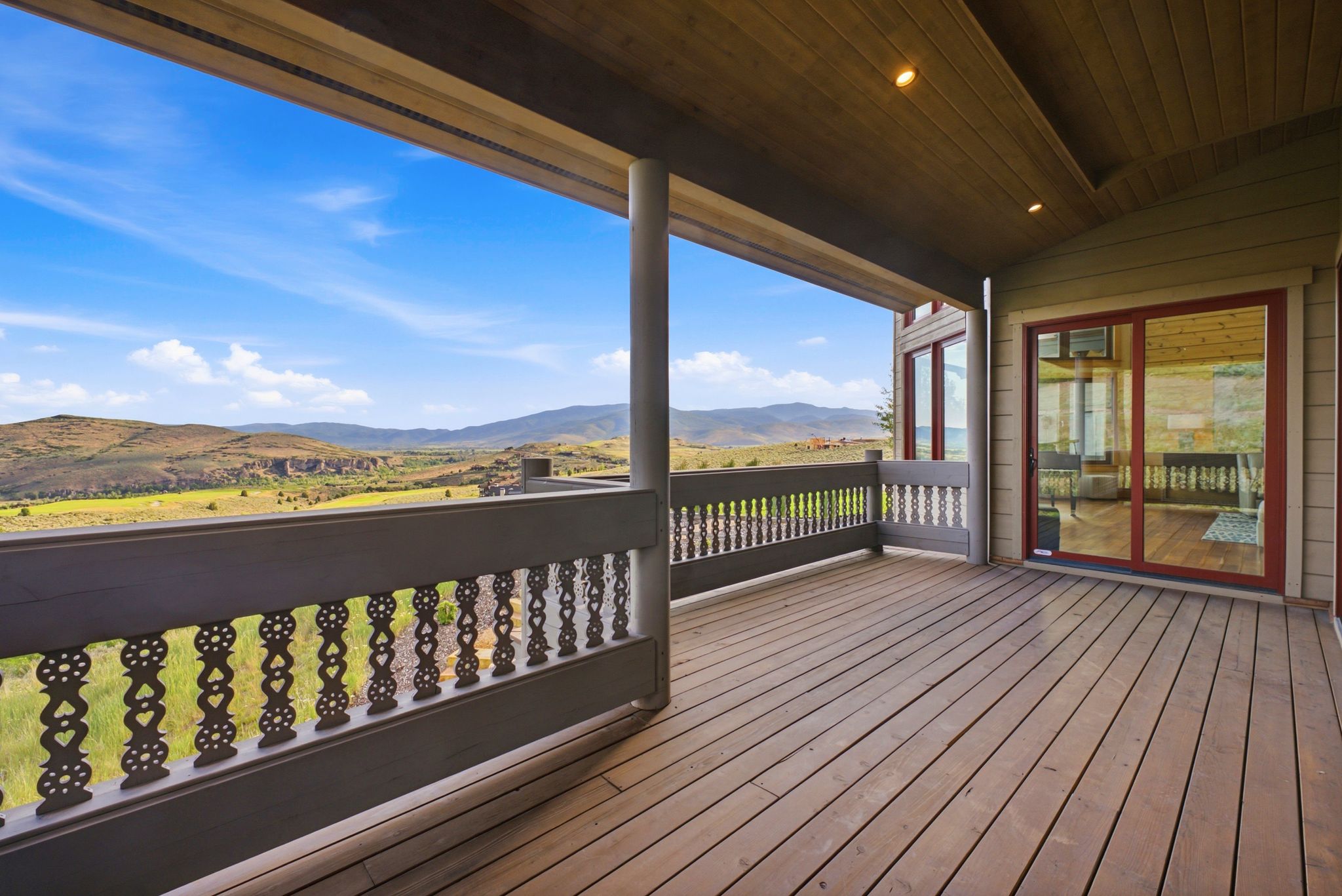 Expansive outdoor deck featuring wood-finish flooring and a decorative railing