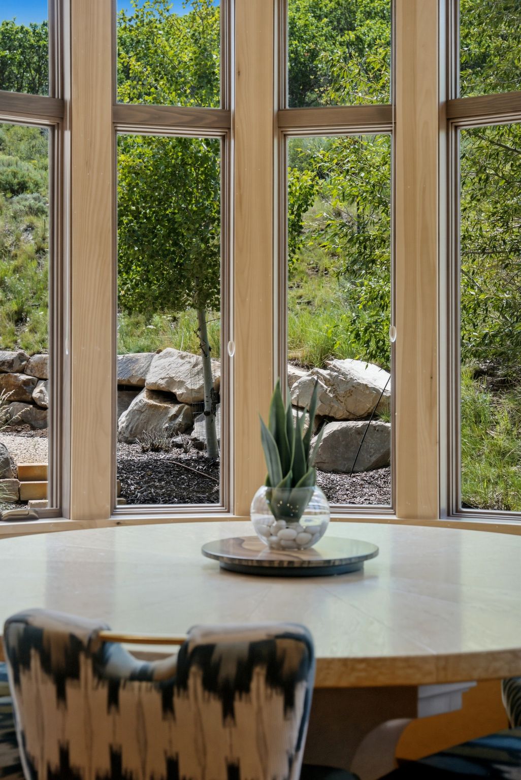 Curved window wall with light wood framing