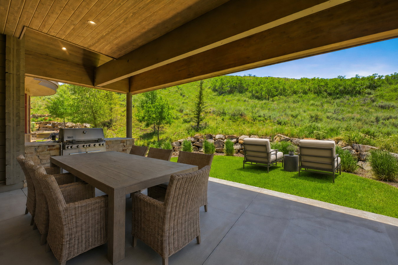 Covered patio featuring a built-in barbecue grill, stone-clad outdoor kitchen, wood-finish ceiling, and recessed lighting