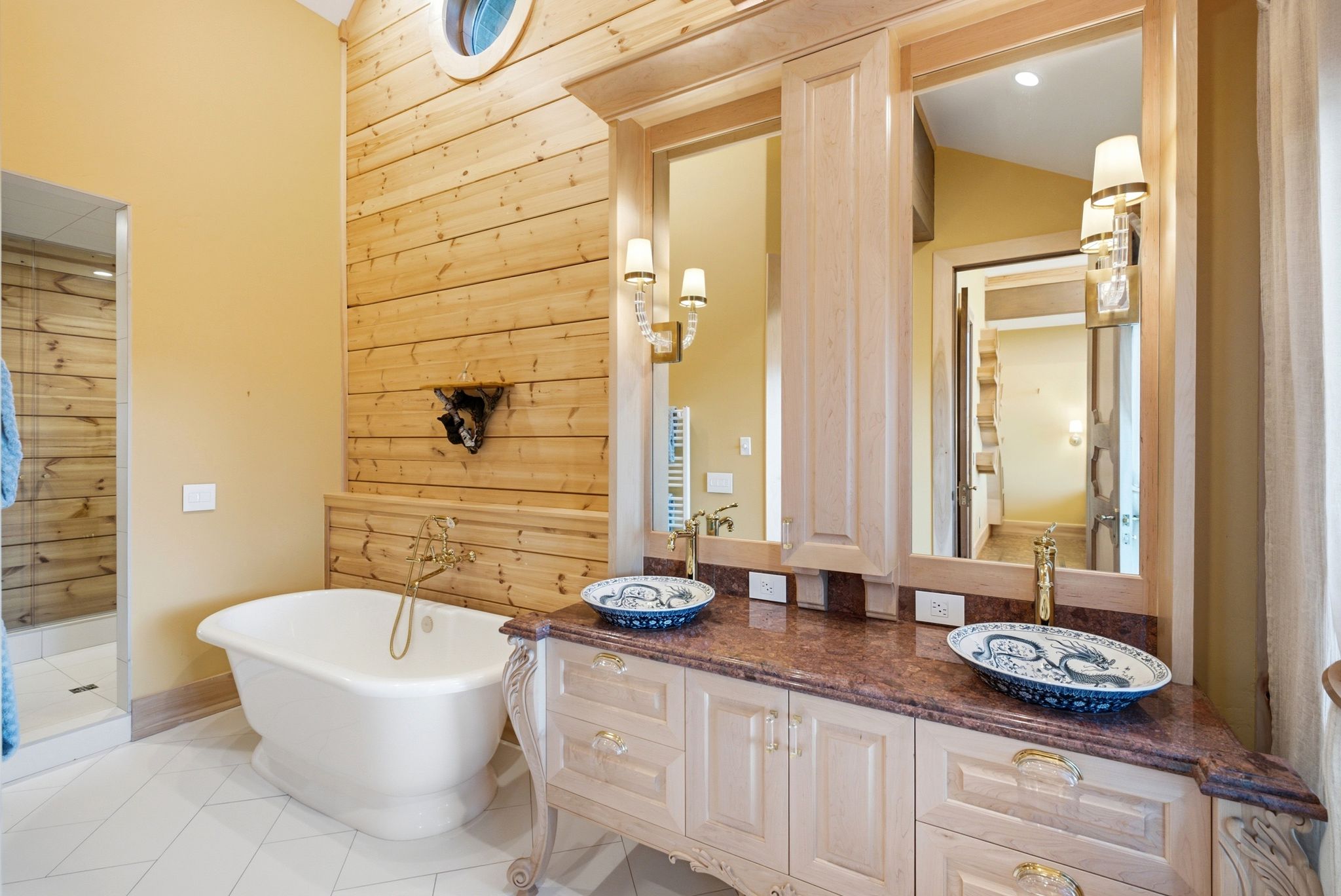 Double vanity with vessel sinks, ornate cabinetry, and a stone countertop