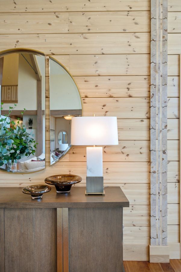 Light wood-paneled walls with vertical stone inlay detailing