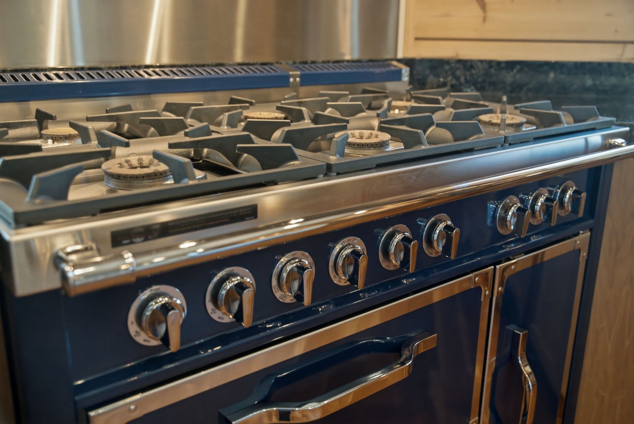 Professional-grade gas range with a blue finish and stainless steel accents