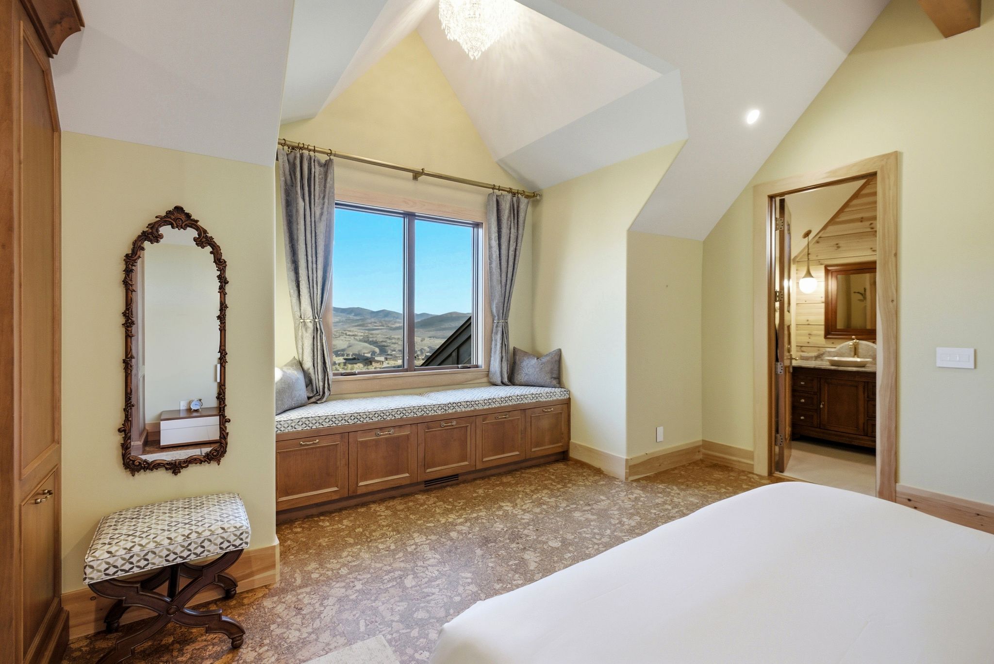 Window seat with built-in storage and panoramic landscape beyond