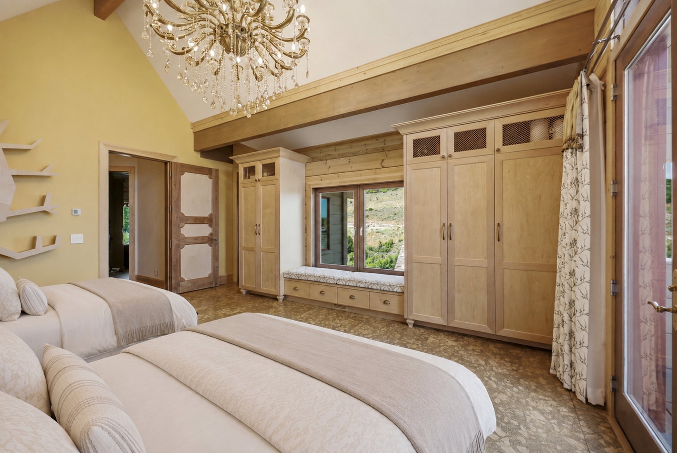 Vaulted ceiling with an ornate chandelier, built-in cabinetry, window seat with storage, and wood-finish flooring