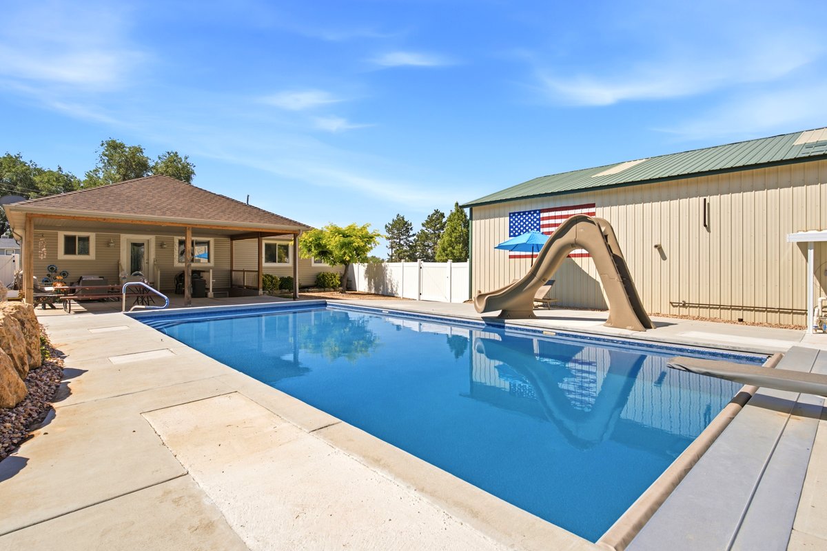 Rectangular swimming pool with a diving board and attached slide