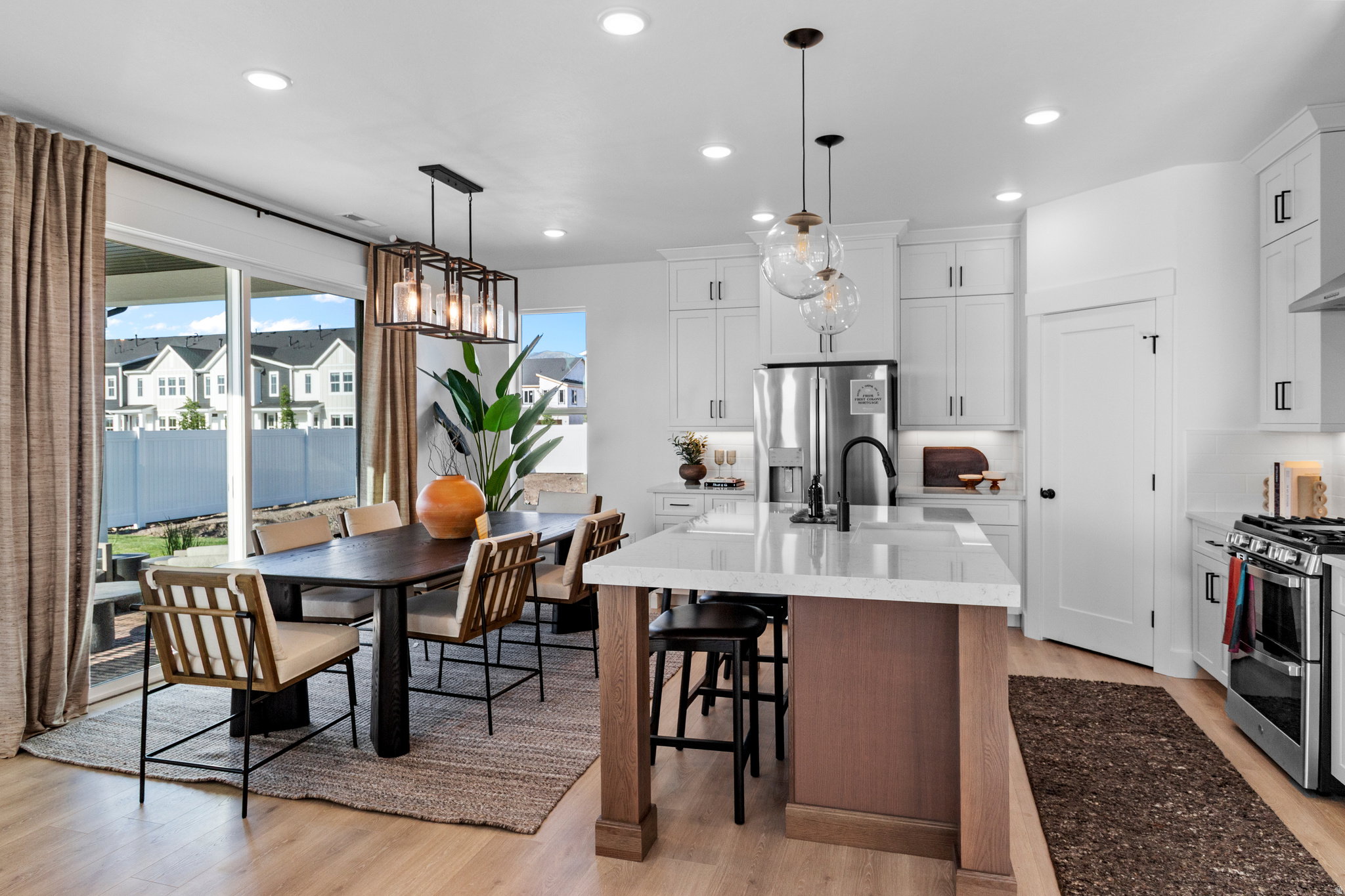Open-concept kitchen and dining area (PICTURE IS FROM A PREVIOUS HOME...COLORS AND FINISHES MAY BE DIFFERENT)