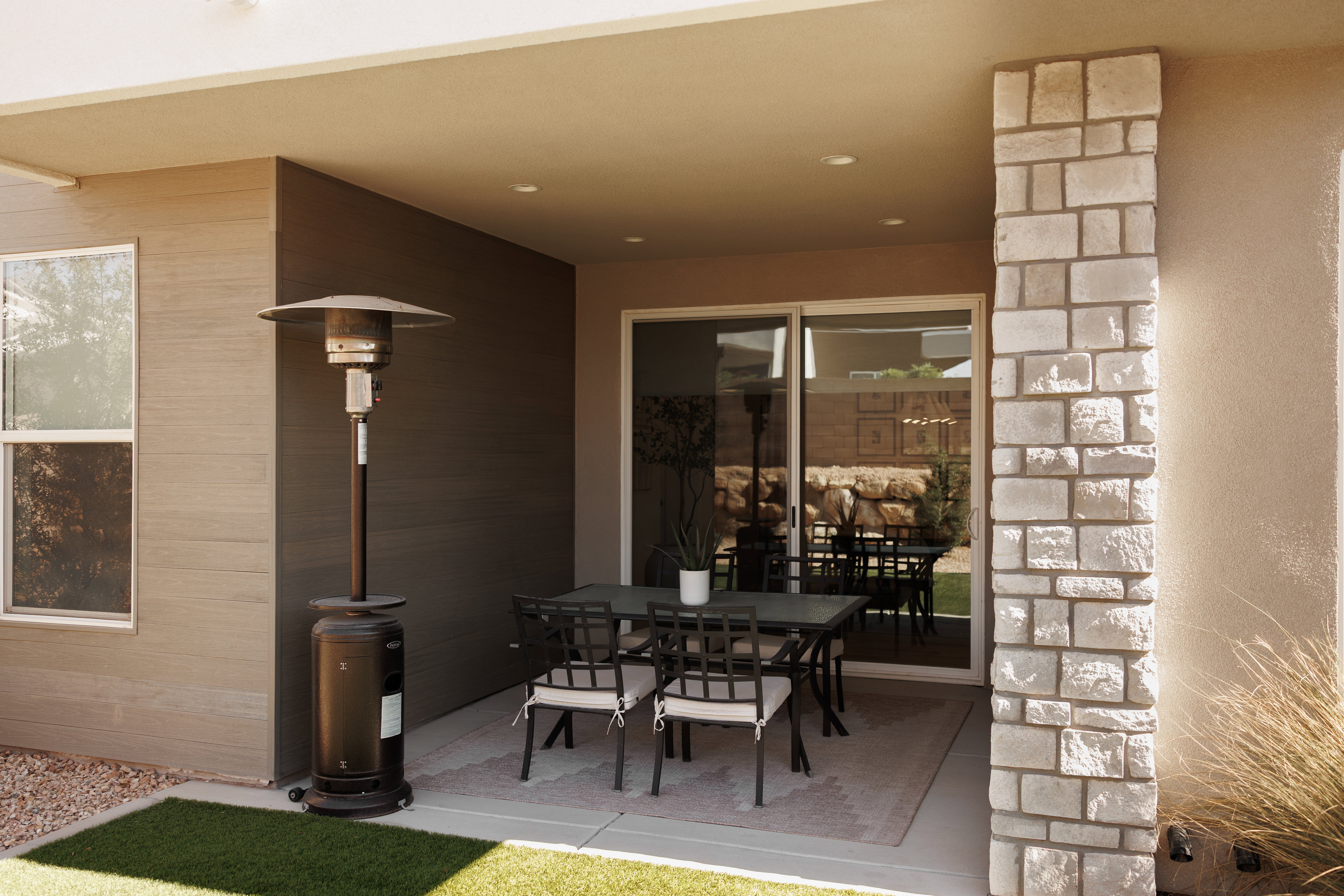Covered patio featuring a concrete slab, recessed lighting, and a stone-clad pillar
