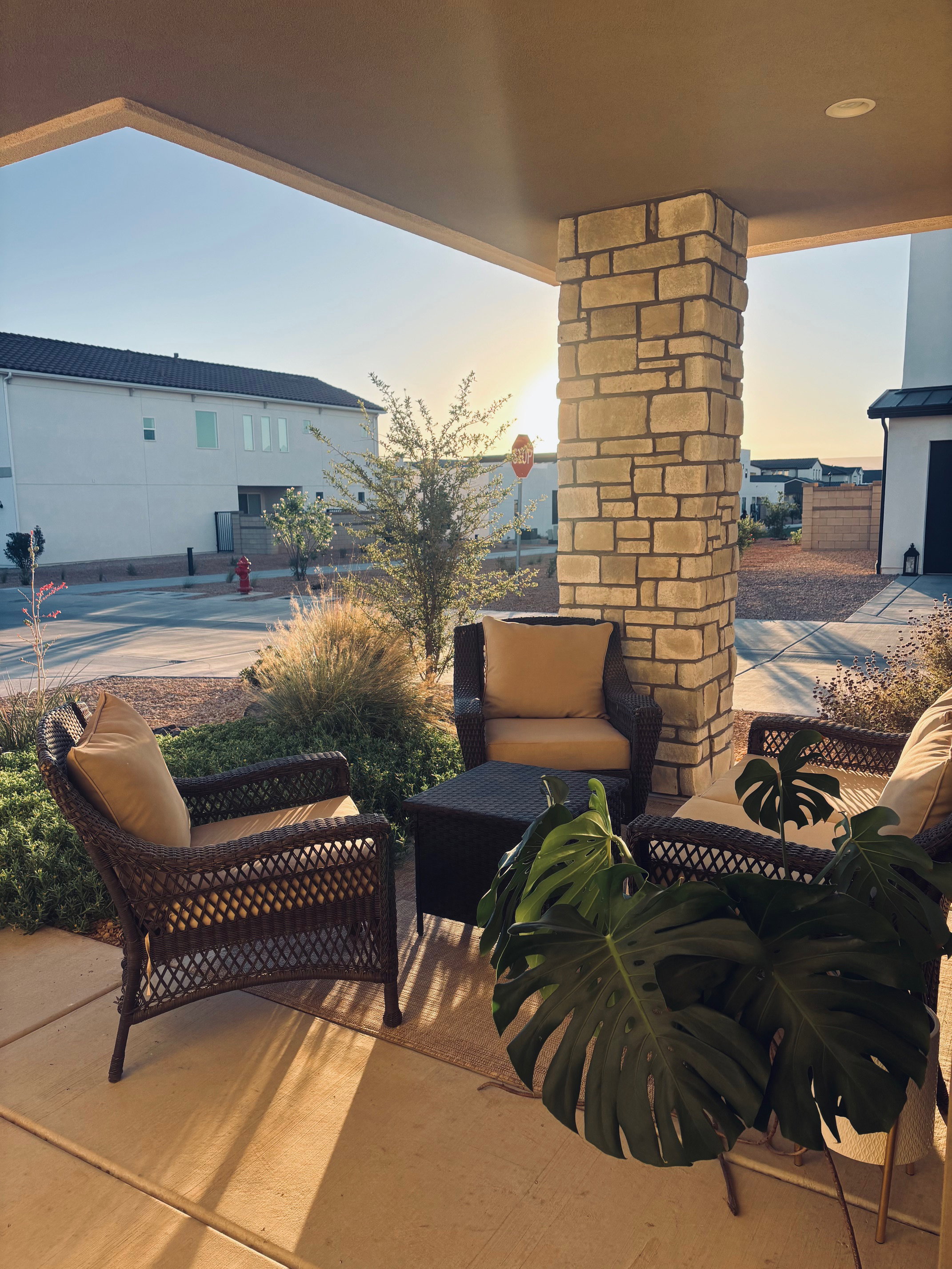 Front porch with a stone-clad pillar and recessed lighting