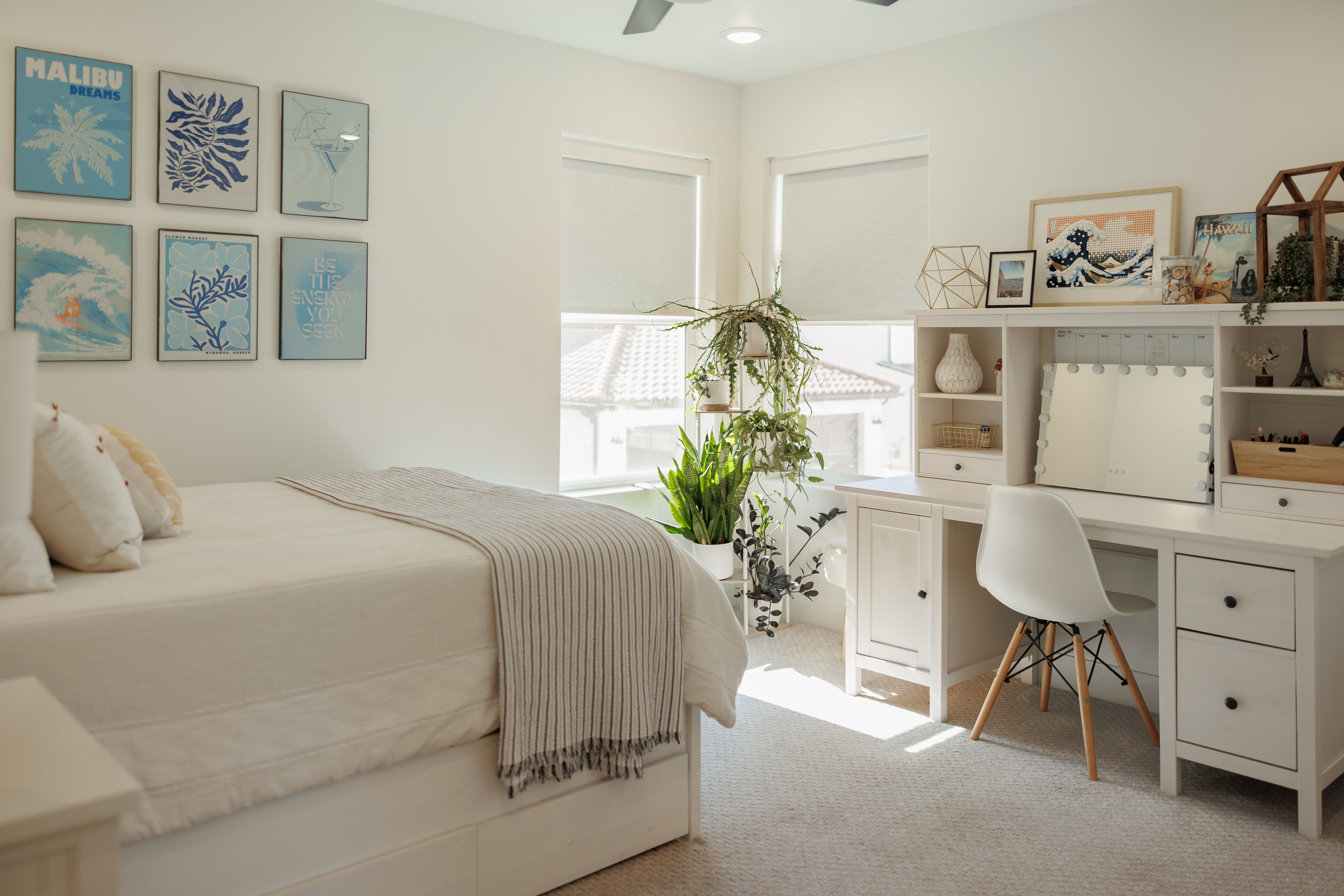 Bright room featuring white walls, light-colored carpeting, and a ceiling fan