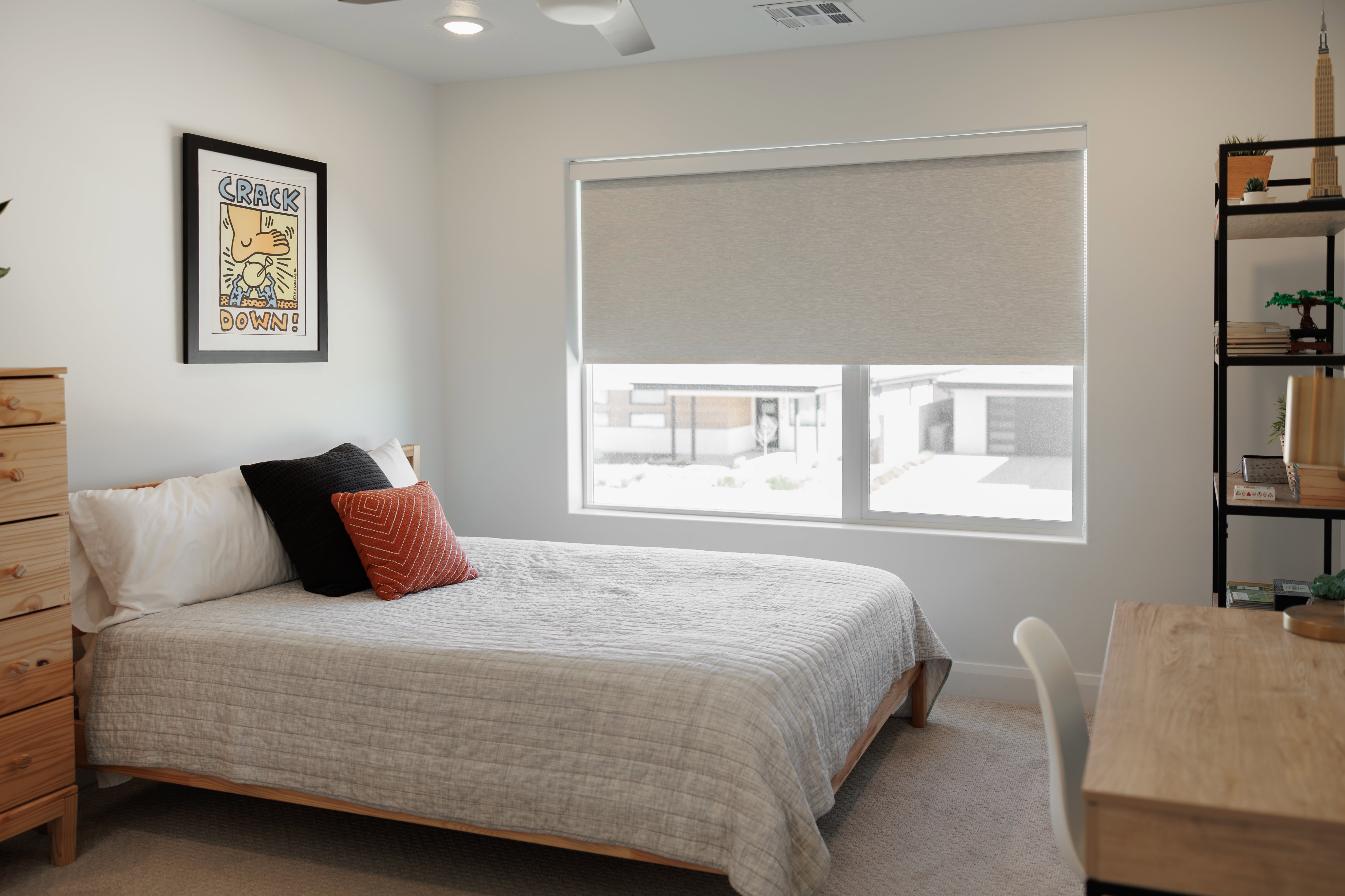 Bright room featuring a large window with roller shades, recessed lighting, and a ceiling fan