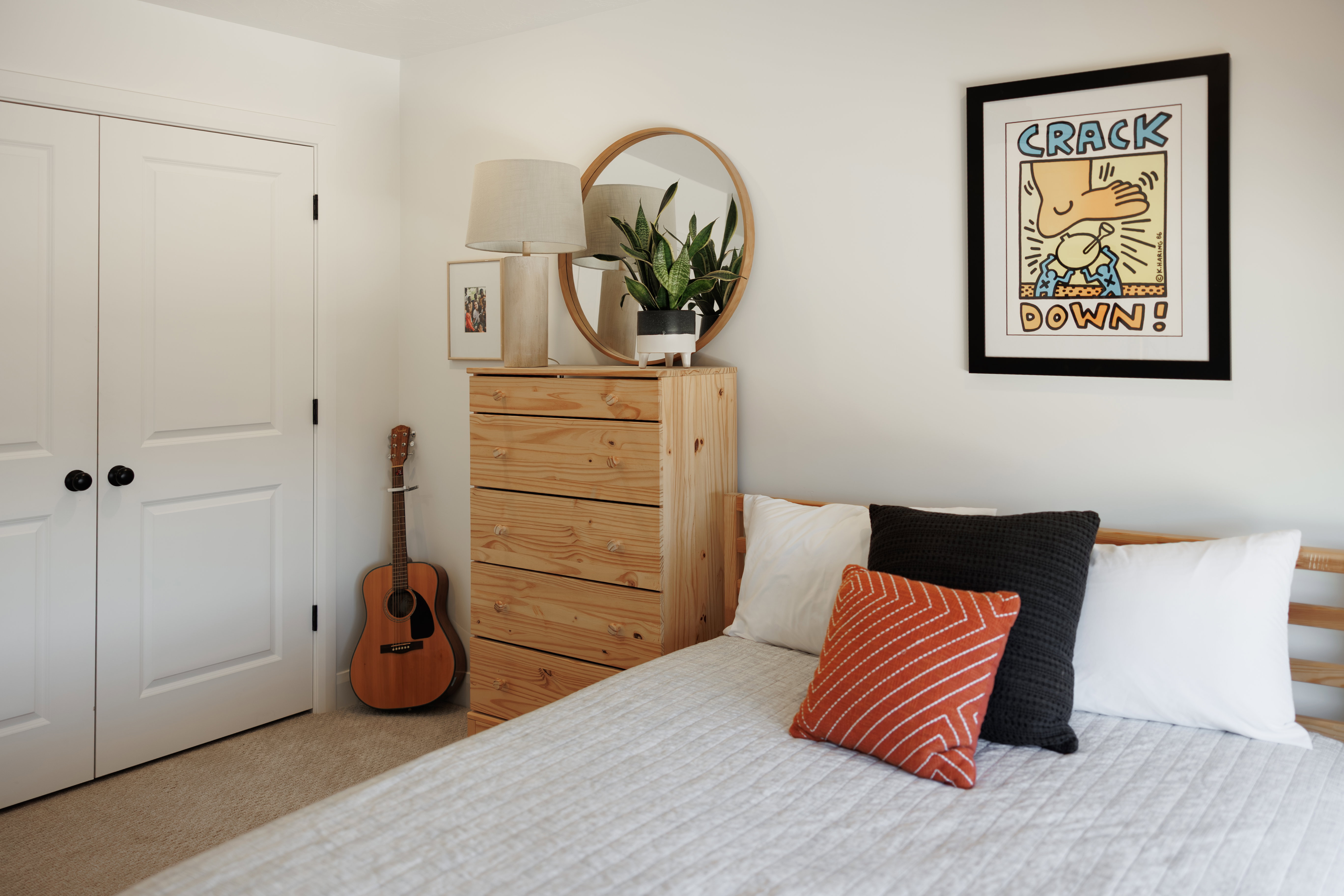 Light-toned wood-finish bed frame with a white quilted spread