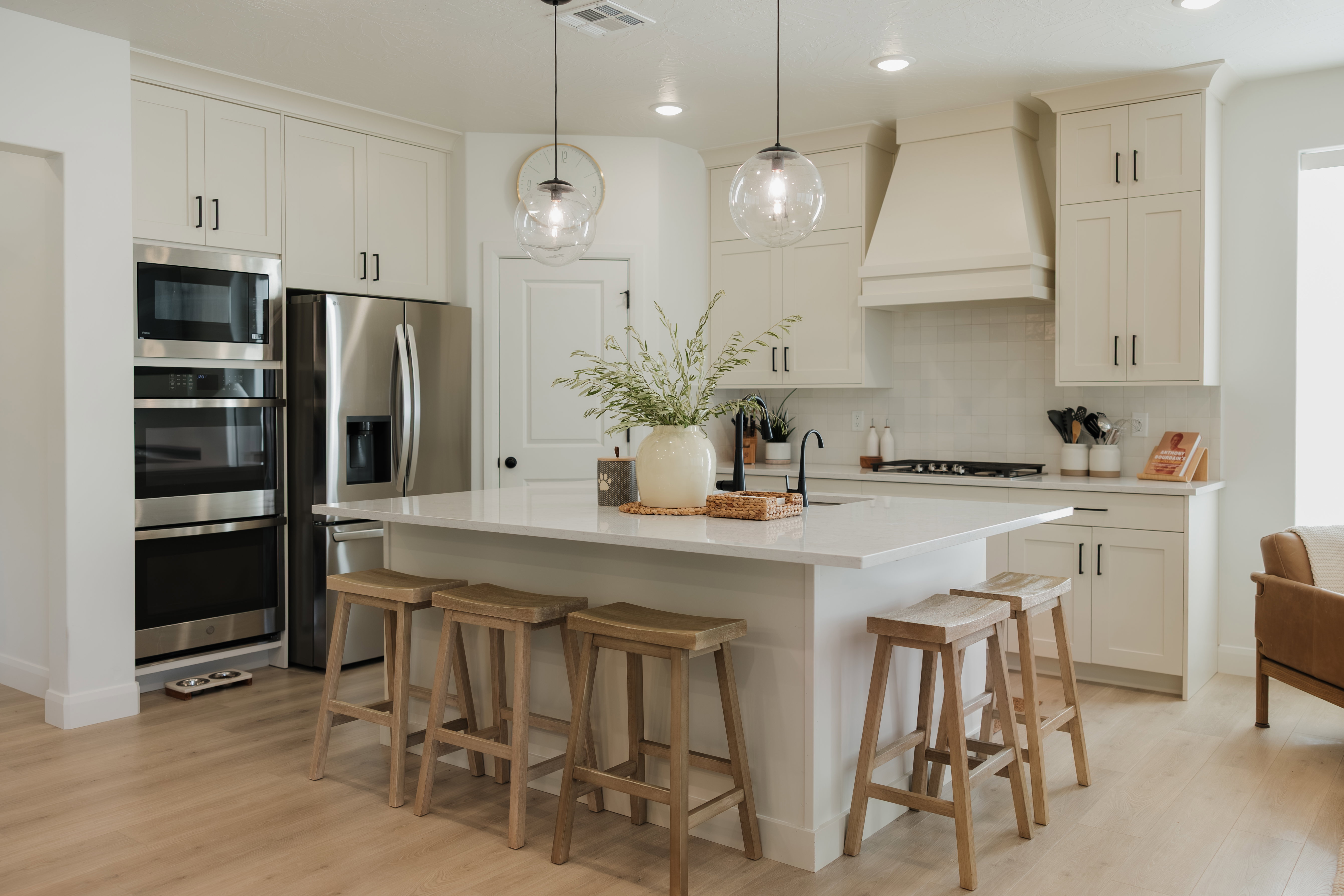 Modern kitchen featuring light cabinetry and a central island with countertop seating